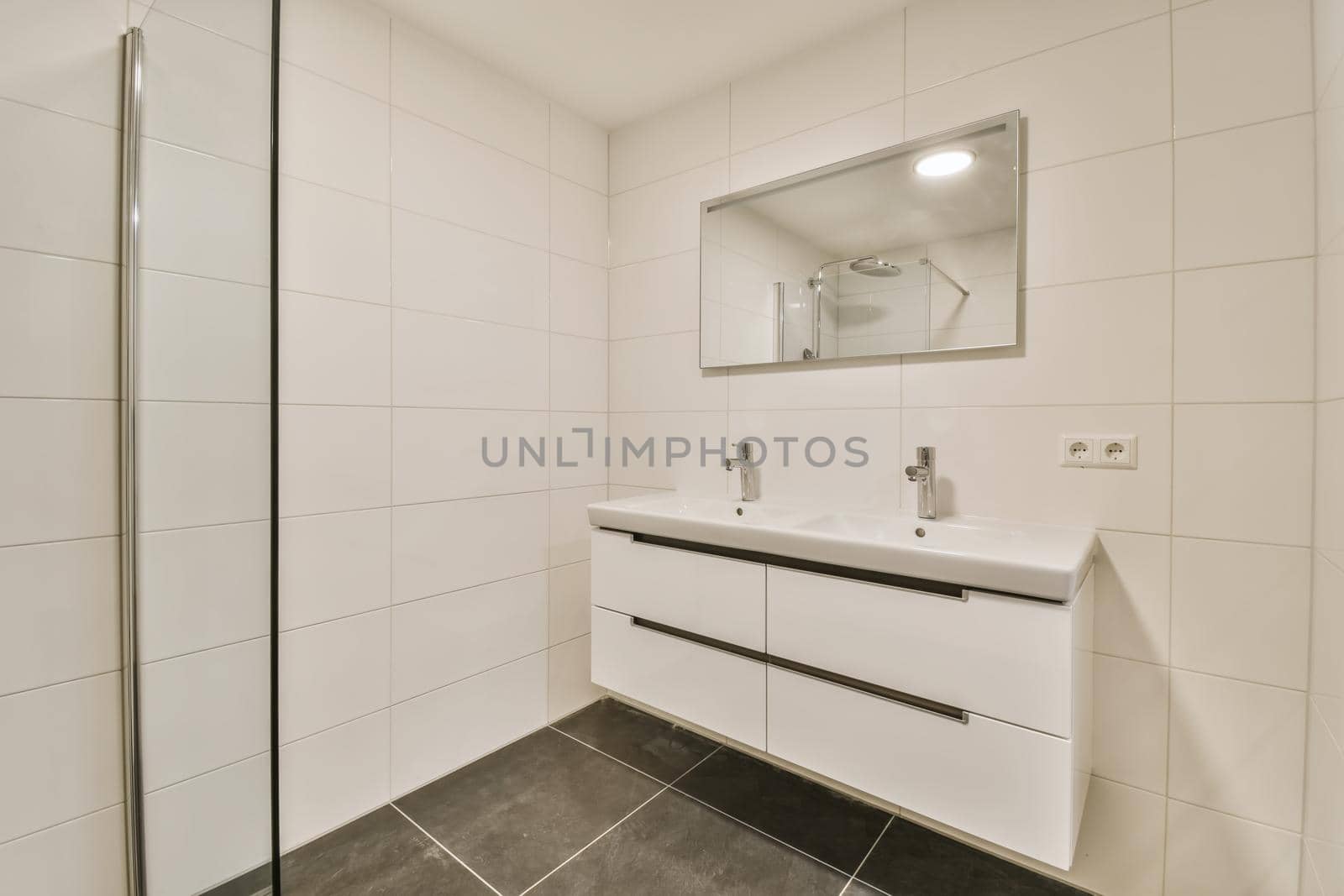 Delightful bathroom with large mirror and long sink
