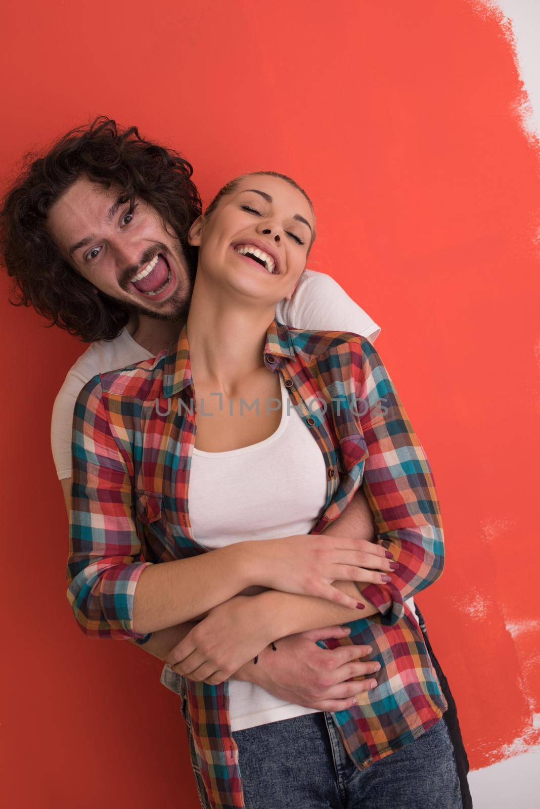 Portrait of a happy young smiling couple in love  over color background