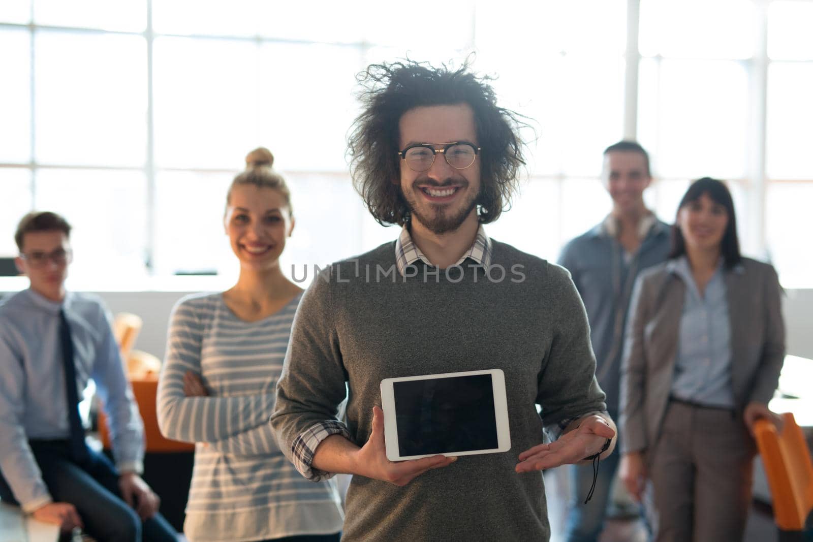 Portrait of a young businessman holding tablet by dotshock