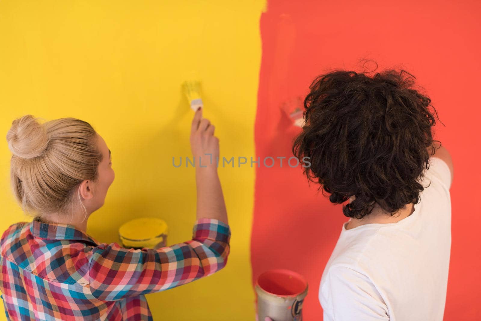 couple painting interior wall by dotshock