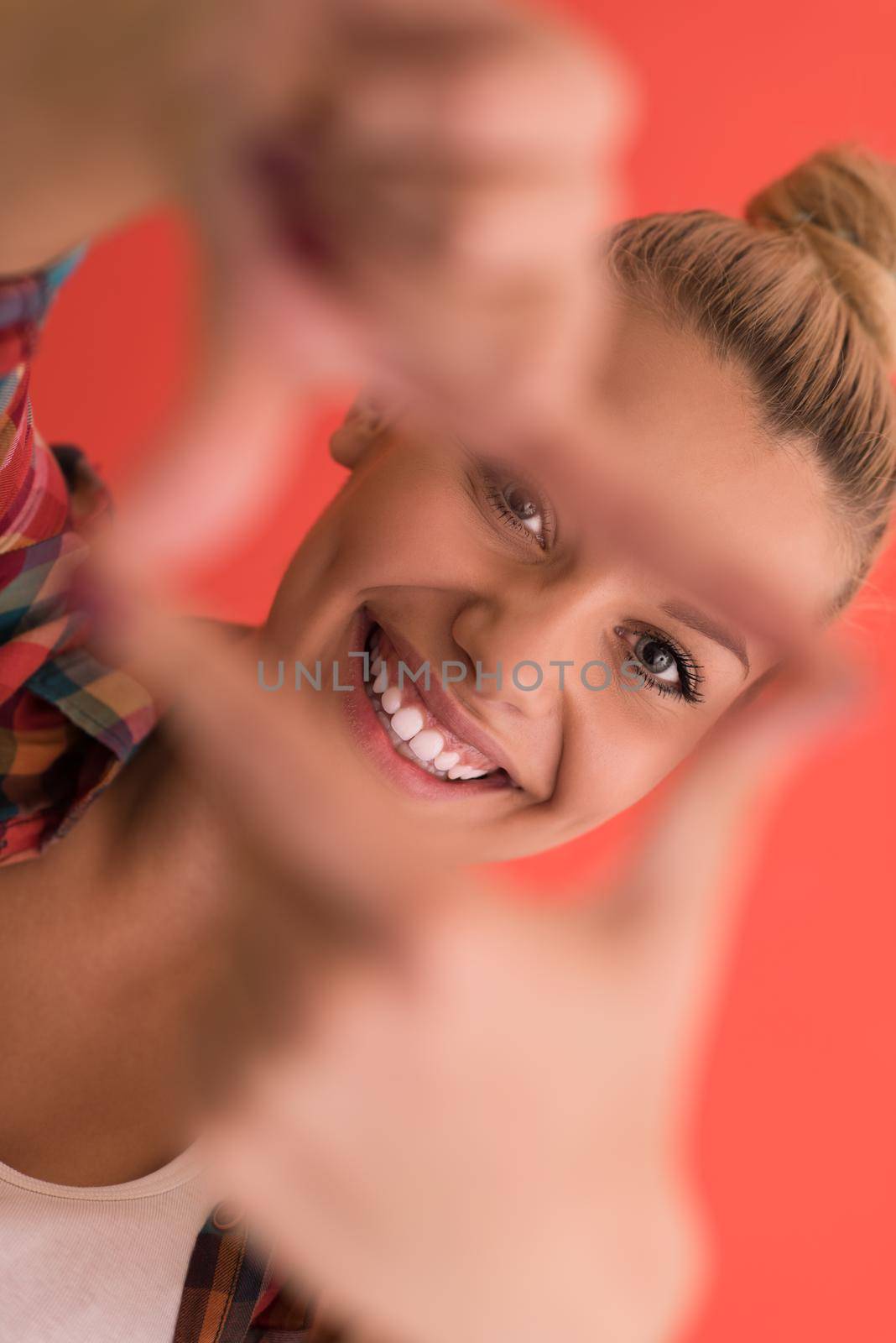 Portrait of a beautiful  young woman with hair bun over color background with copyspace expressing different emotions