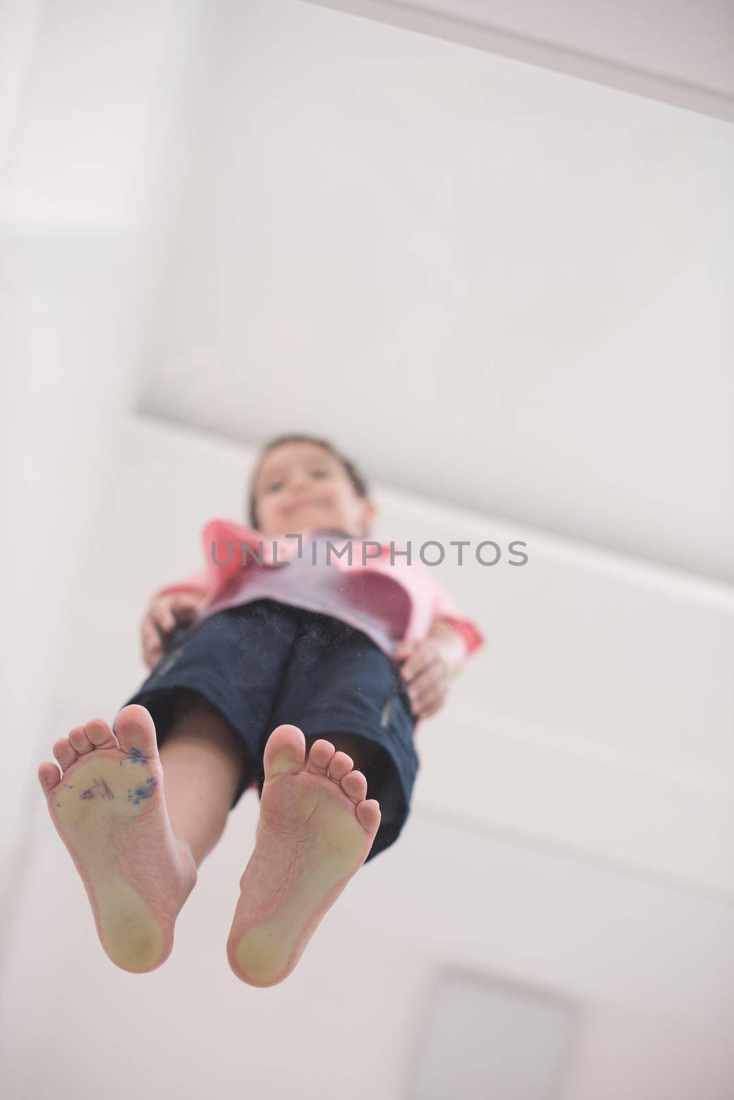 little boy standing on transparent glass floor by dotshock