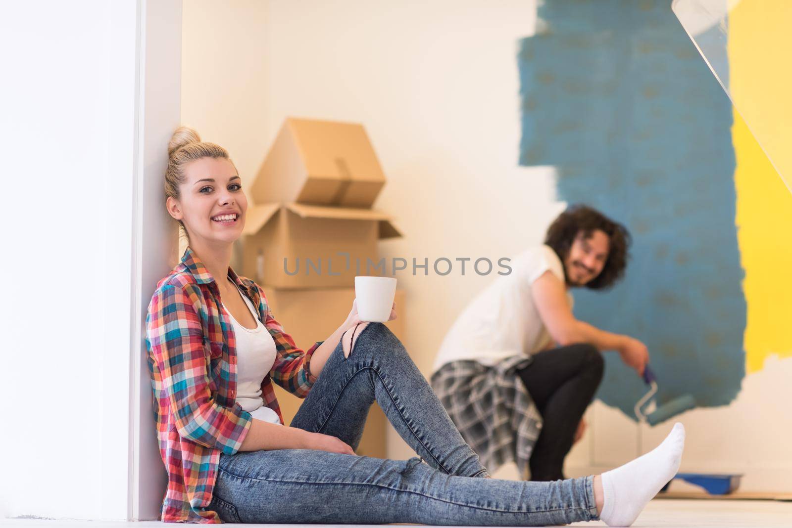 young couple doing home renovations by dotshock