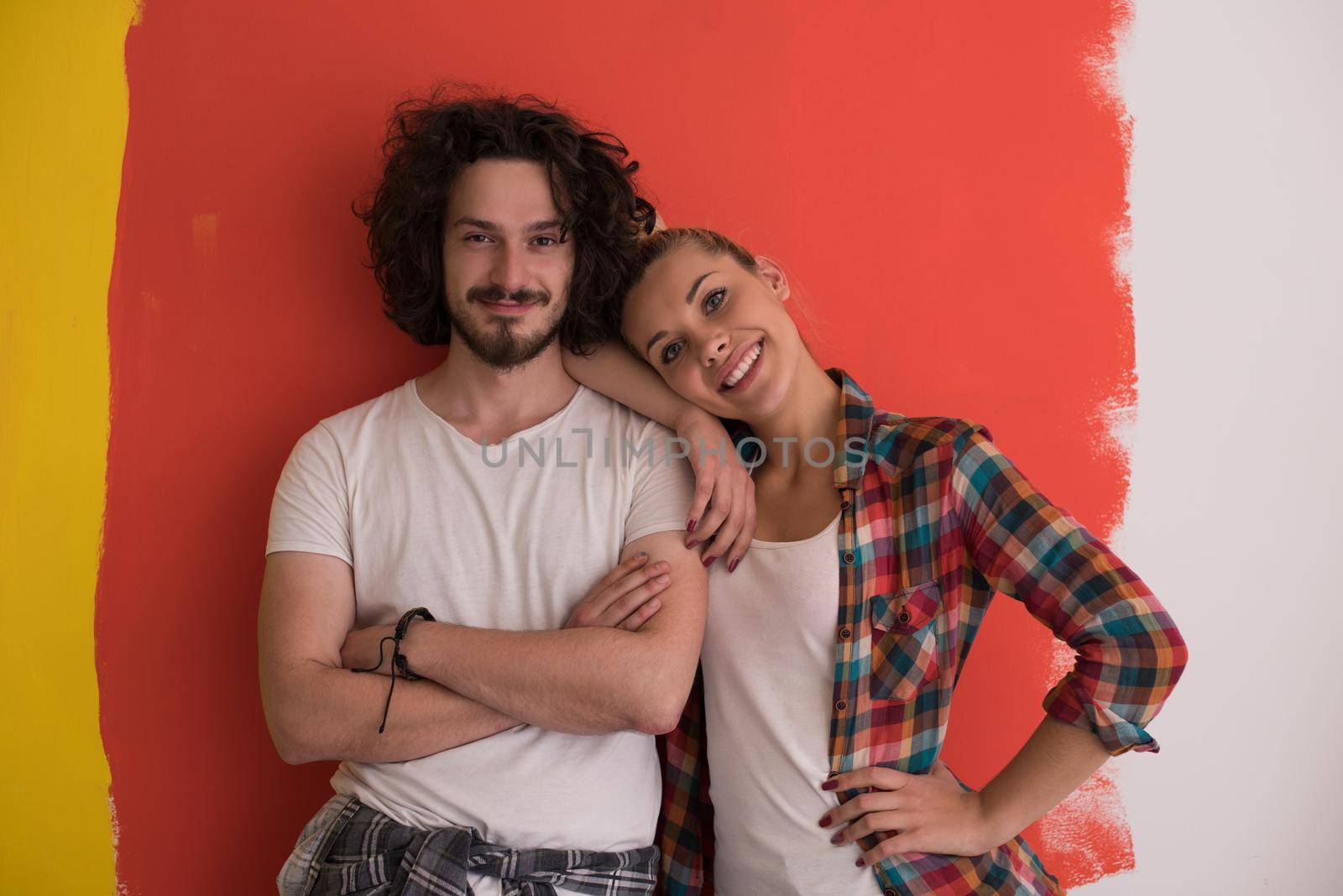 Portrait of a happy young smiling couple in love  over color background