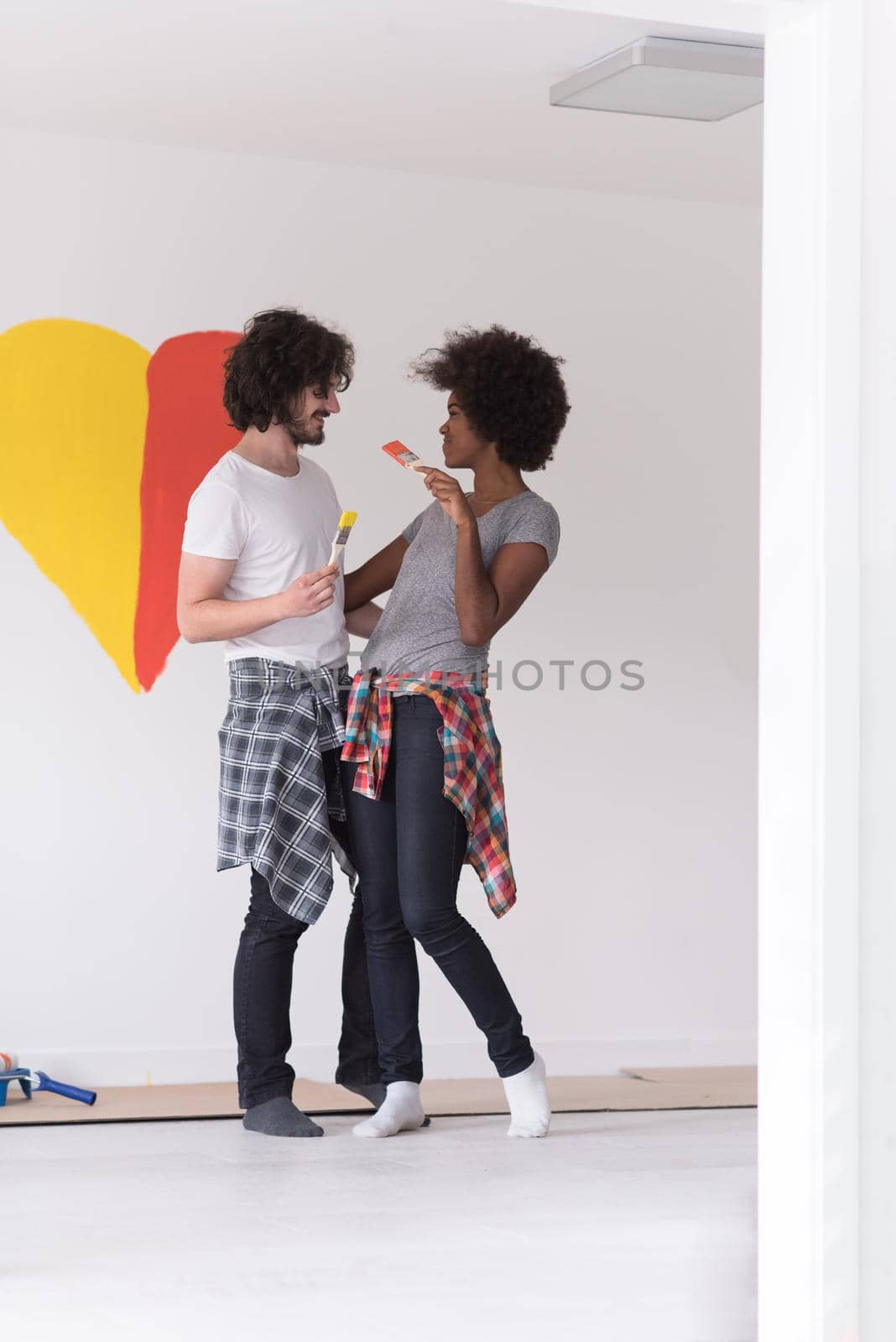 couple with painted heart on wall by dotshock