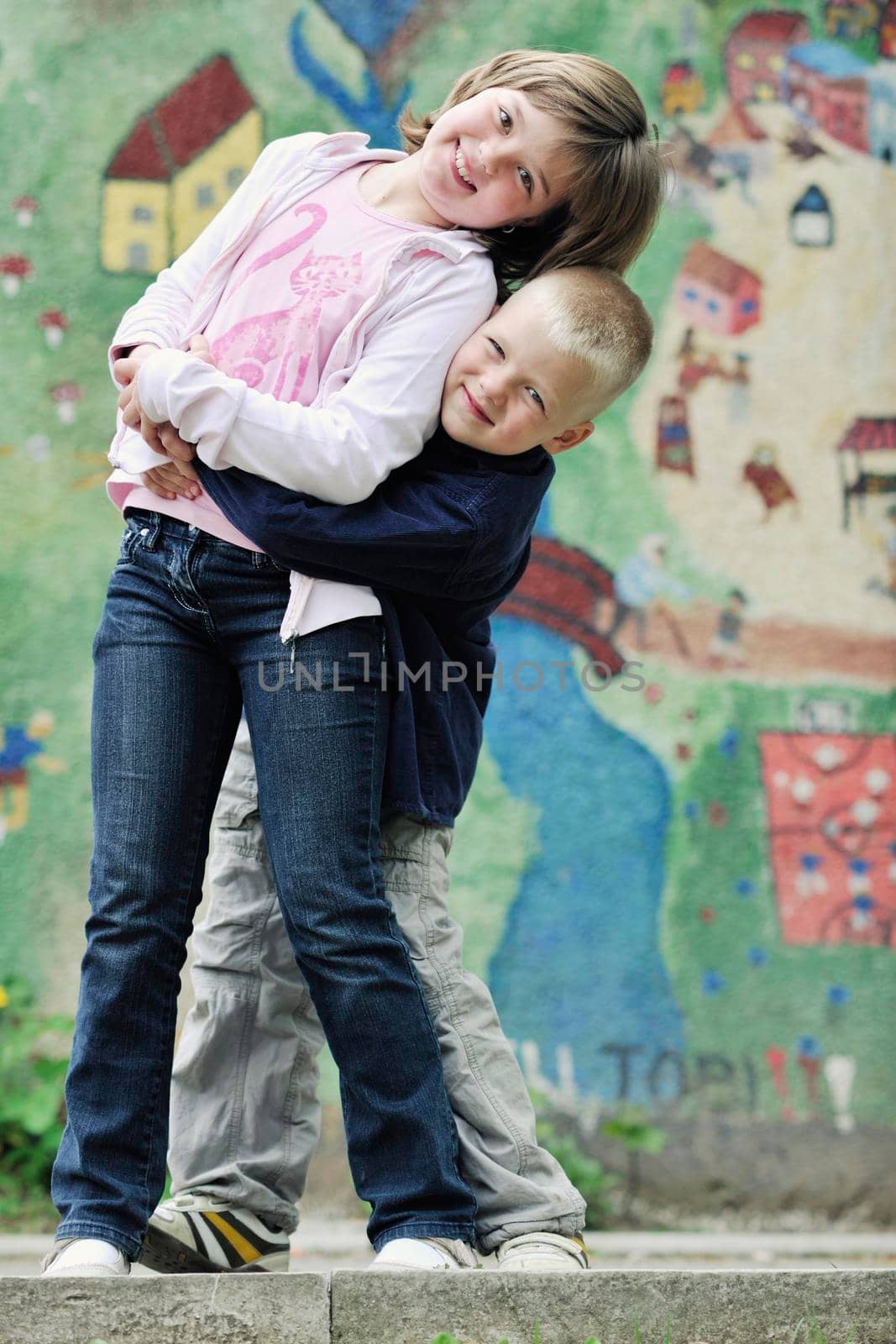 happy brother and sister outdoor in park by dotshock