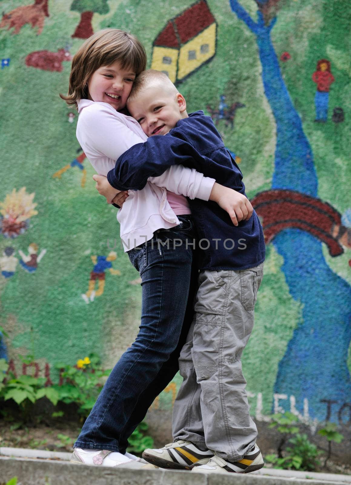 happy brother and sister outdoor in park by dotshock