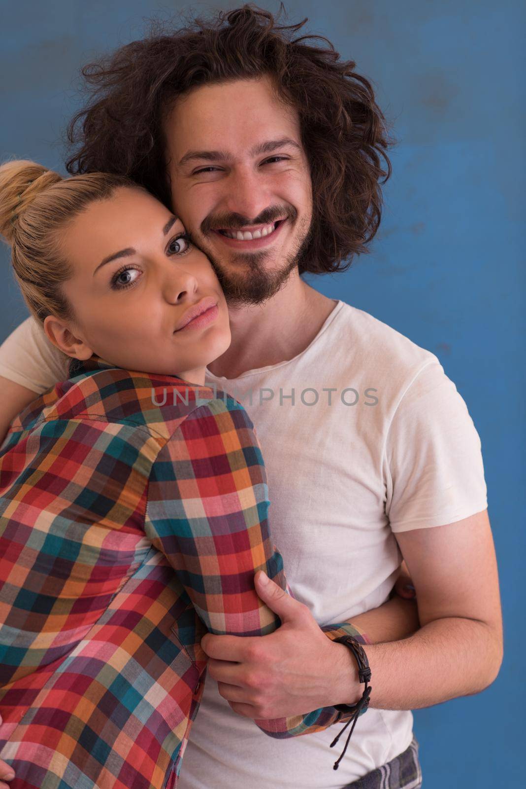 Portrait of a happy young smiling couple in love  over color background