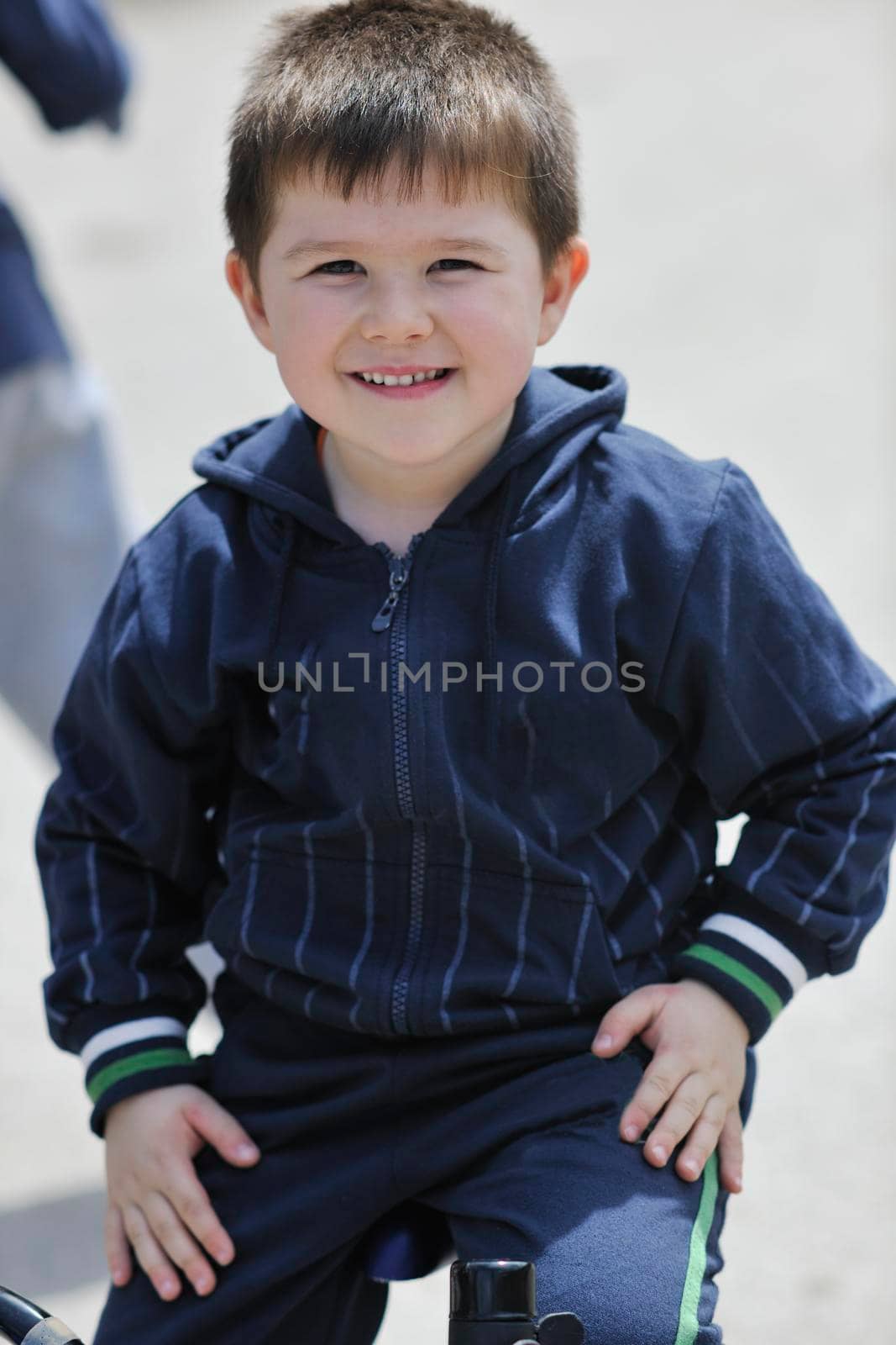 cute little boy outdoor portrait while learning to drive first bicycle 