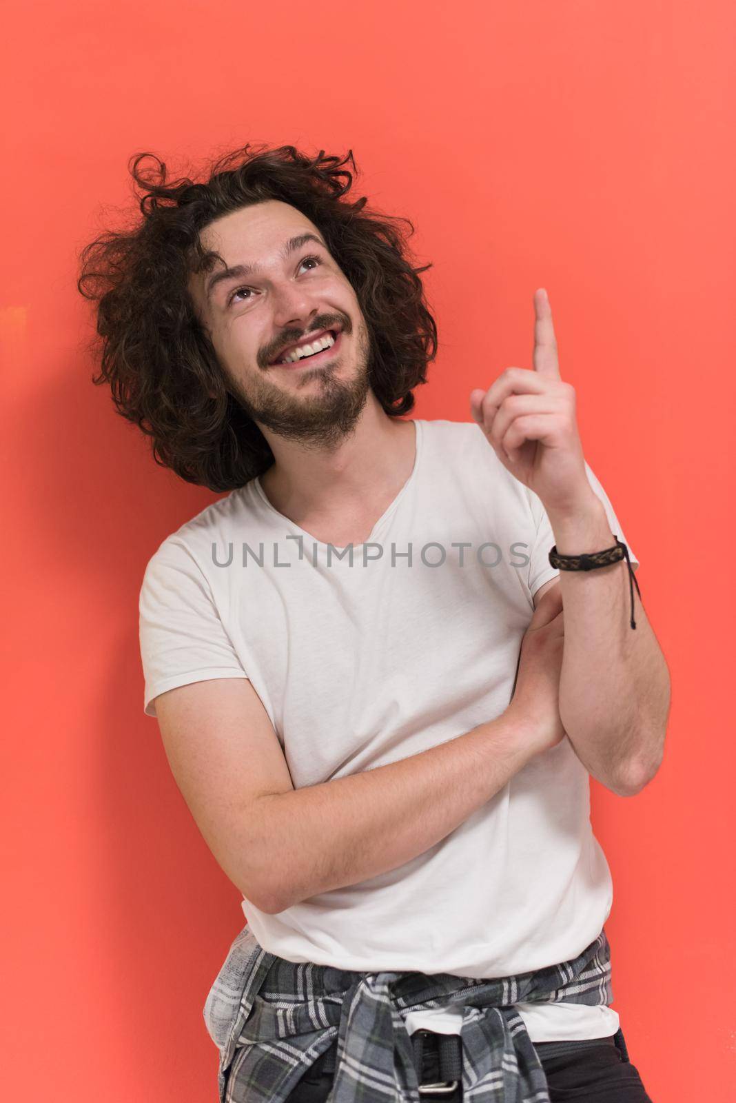 Portrait of a beautiful  young man with funny hair over color background with copyspace expressing different emotions