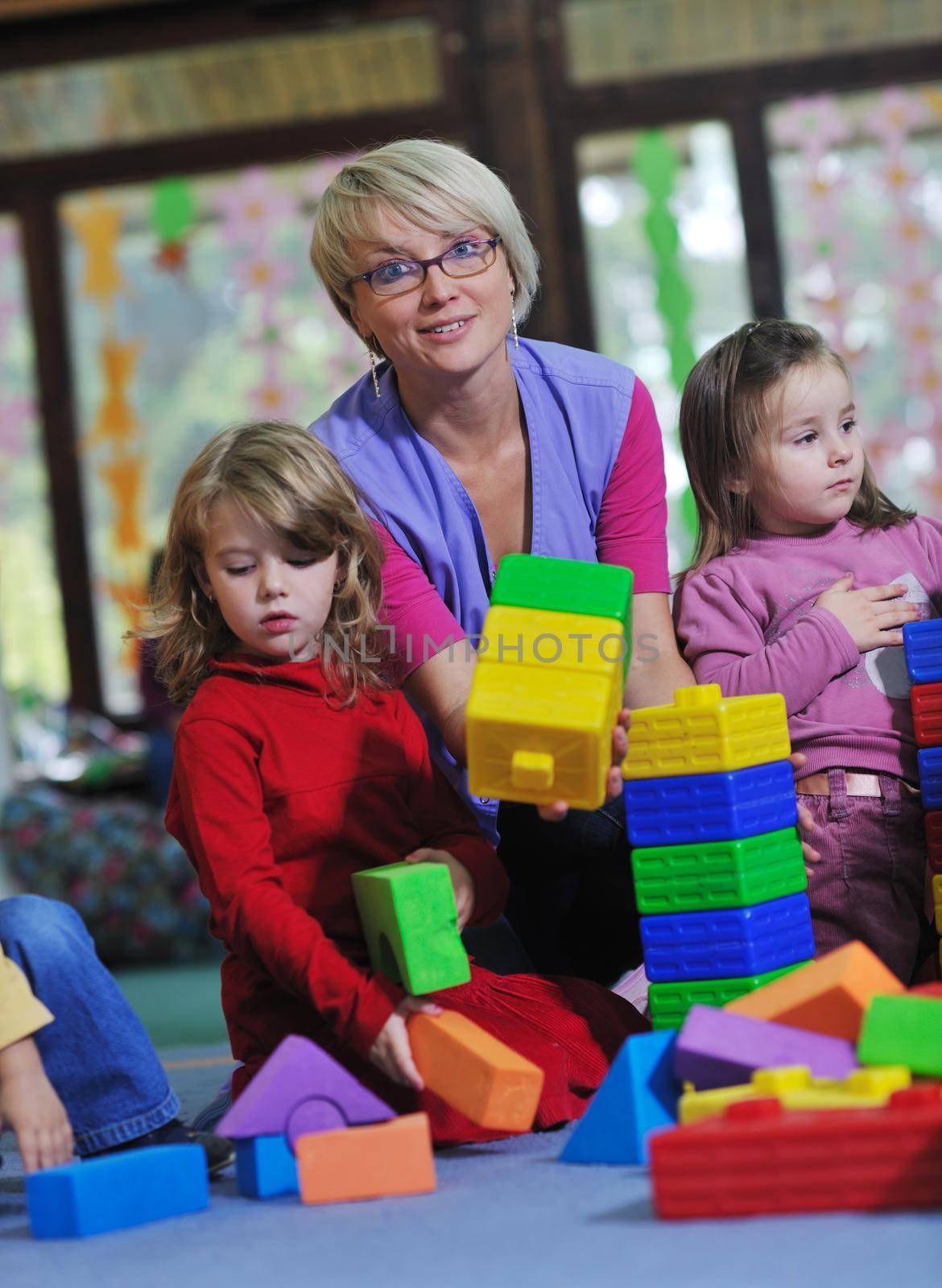 happy child kids group have fun and play at kindergarden indoor preschool education concept with  teacher