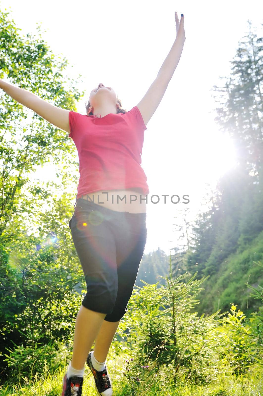 happy girl jump in air outdoor in nature