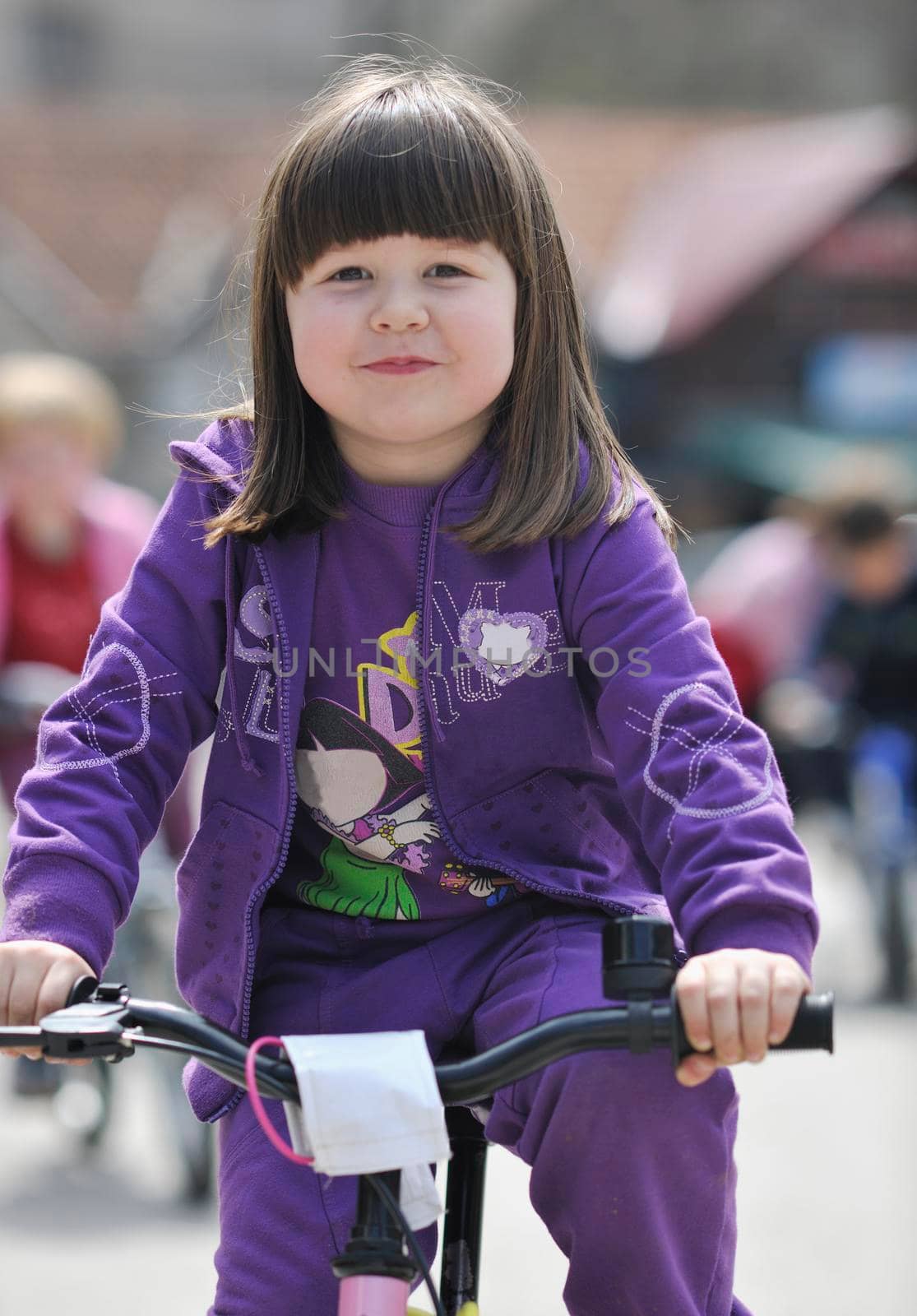 cute little girl driving bicyle at sunny day by dotshock