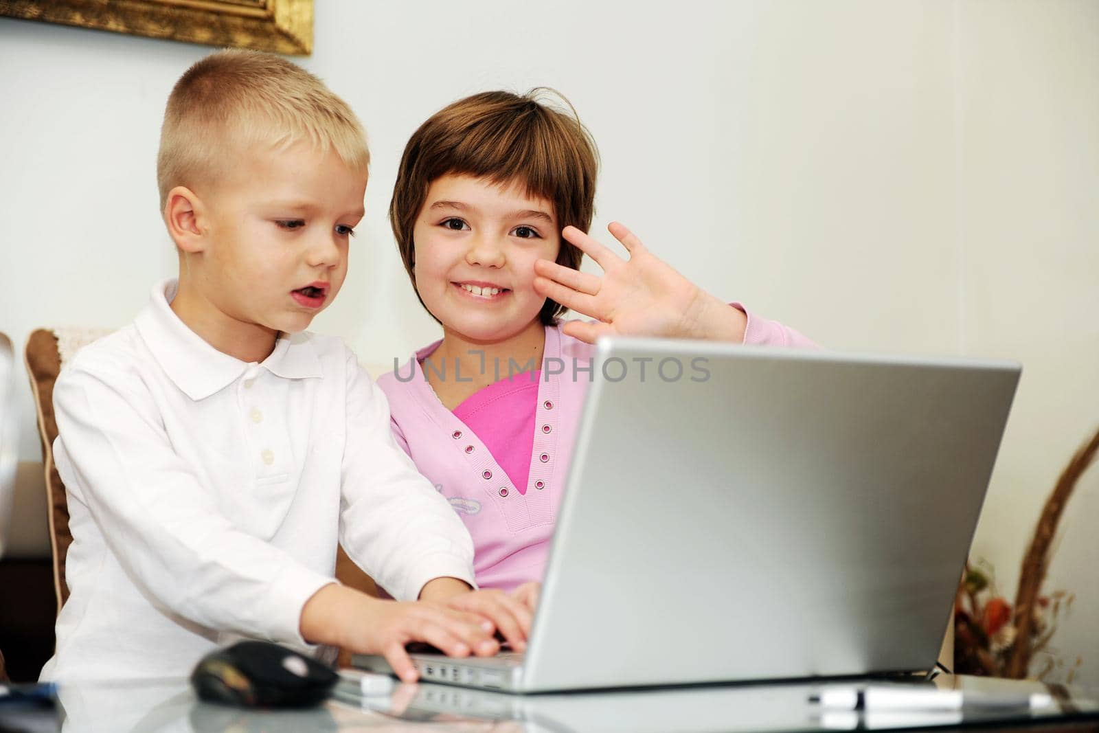 childrens have fun and playing games on laptop computer by dotshock