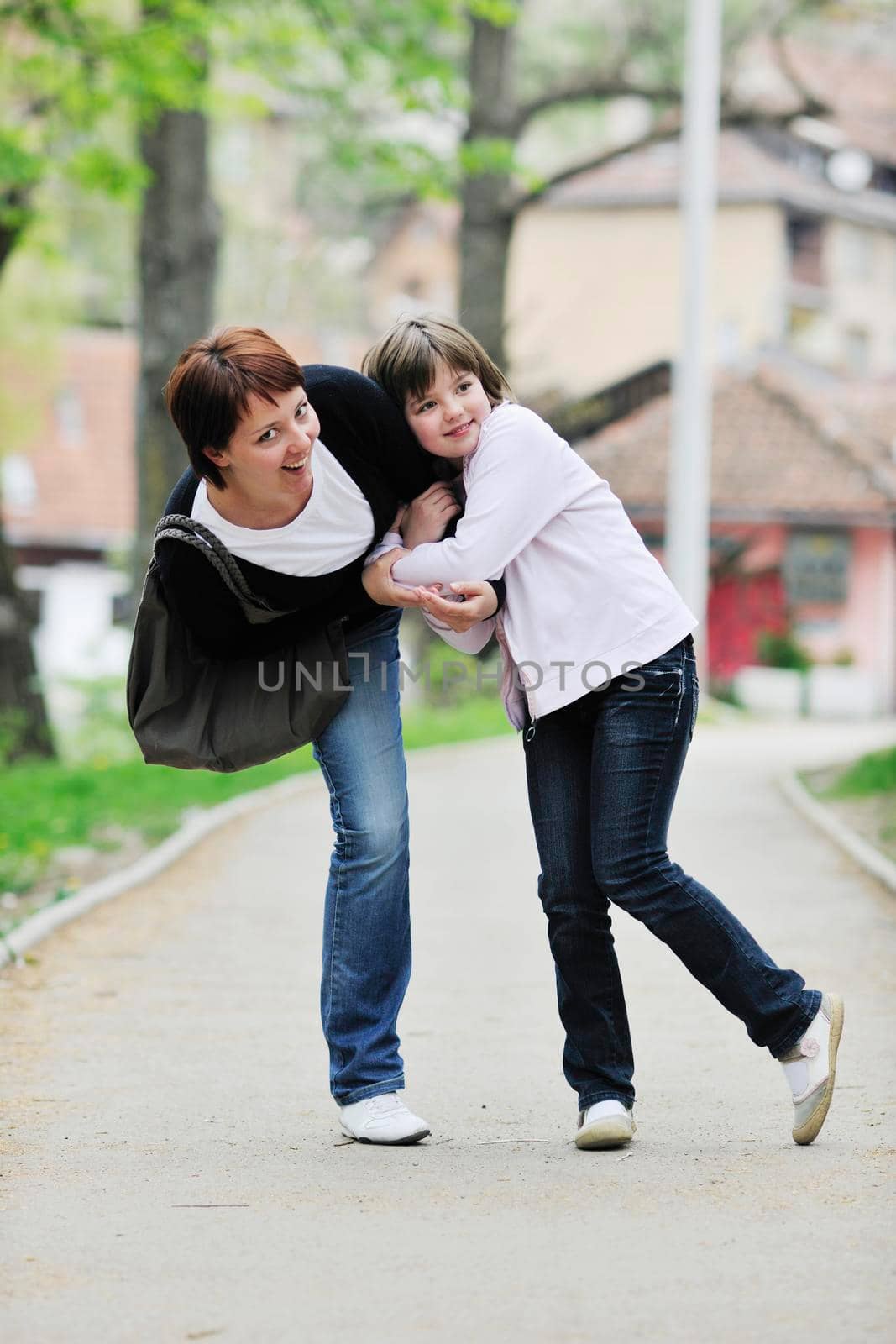 happy oung mother and daughter have fun outdoor 