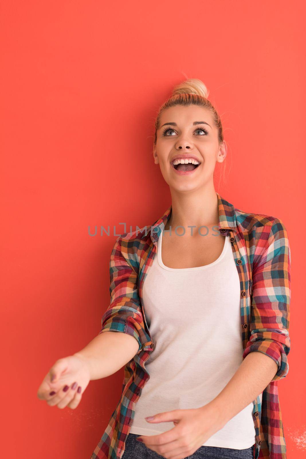beautiful  young woman with hair bun plays with apple over color background with copyspace expressing different emotions