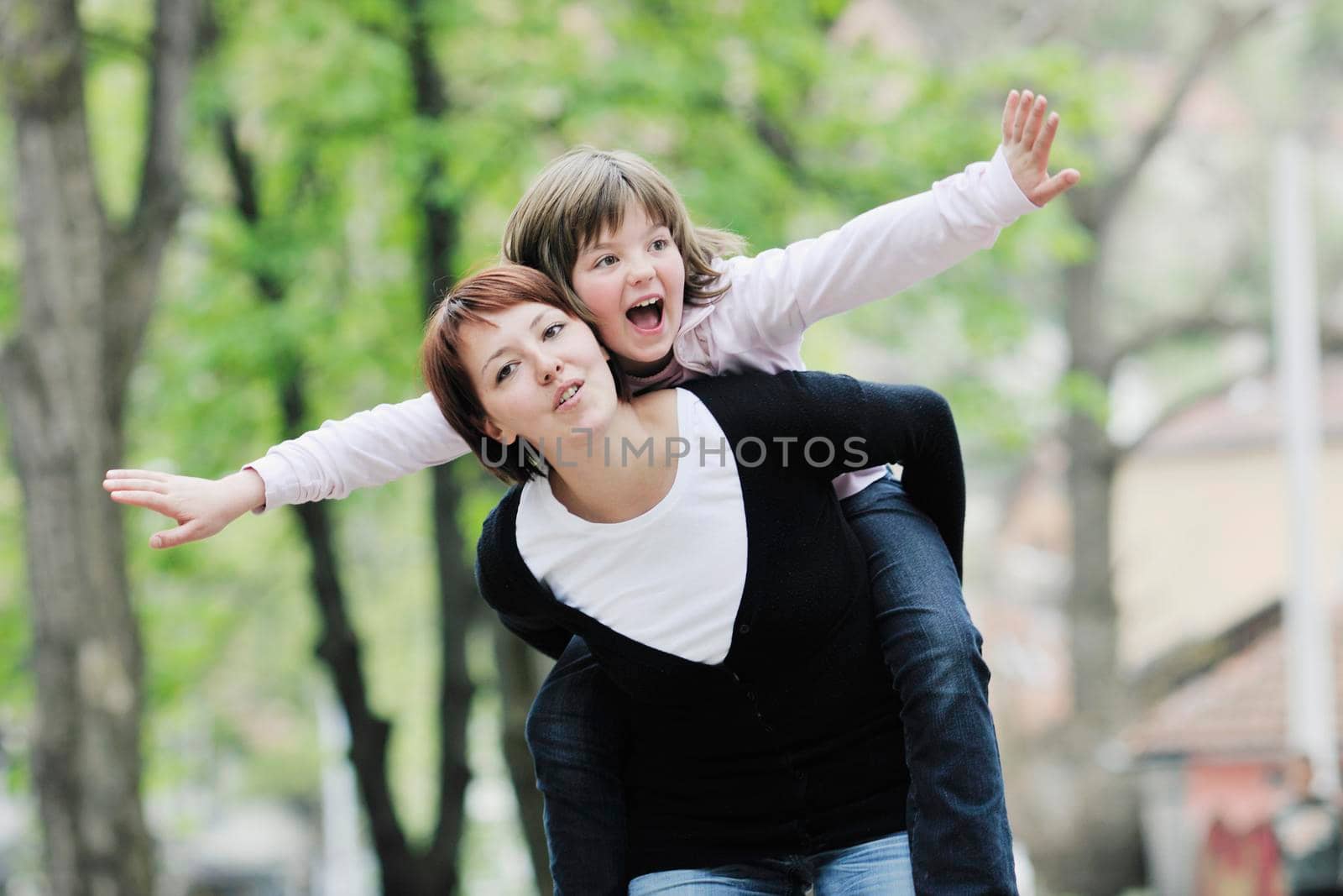 happy girl and mom outdoor by dotshock