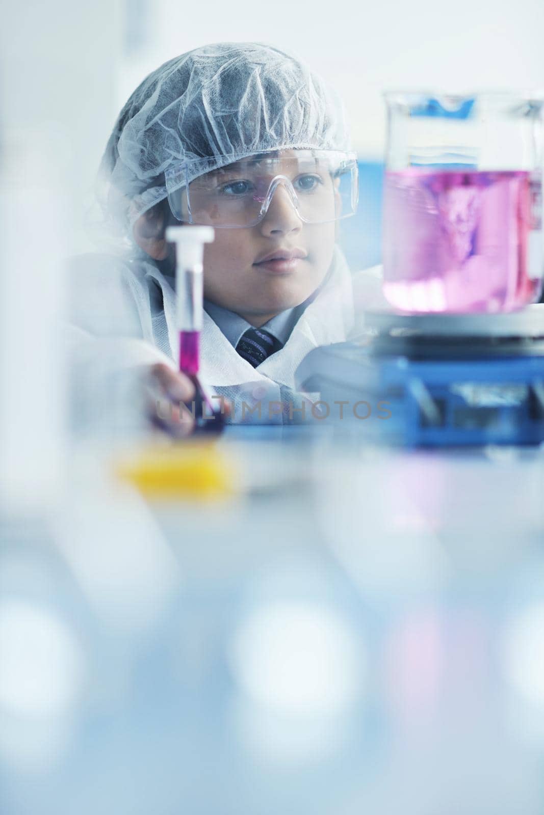 cute little male child have experiment with test tubes in bright modern lab