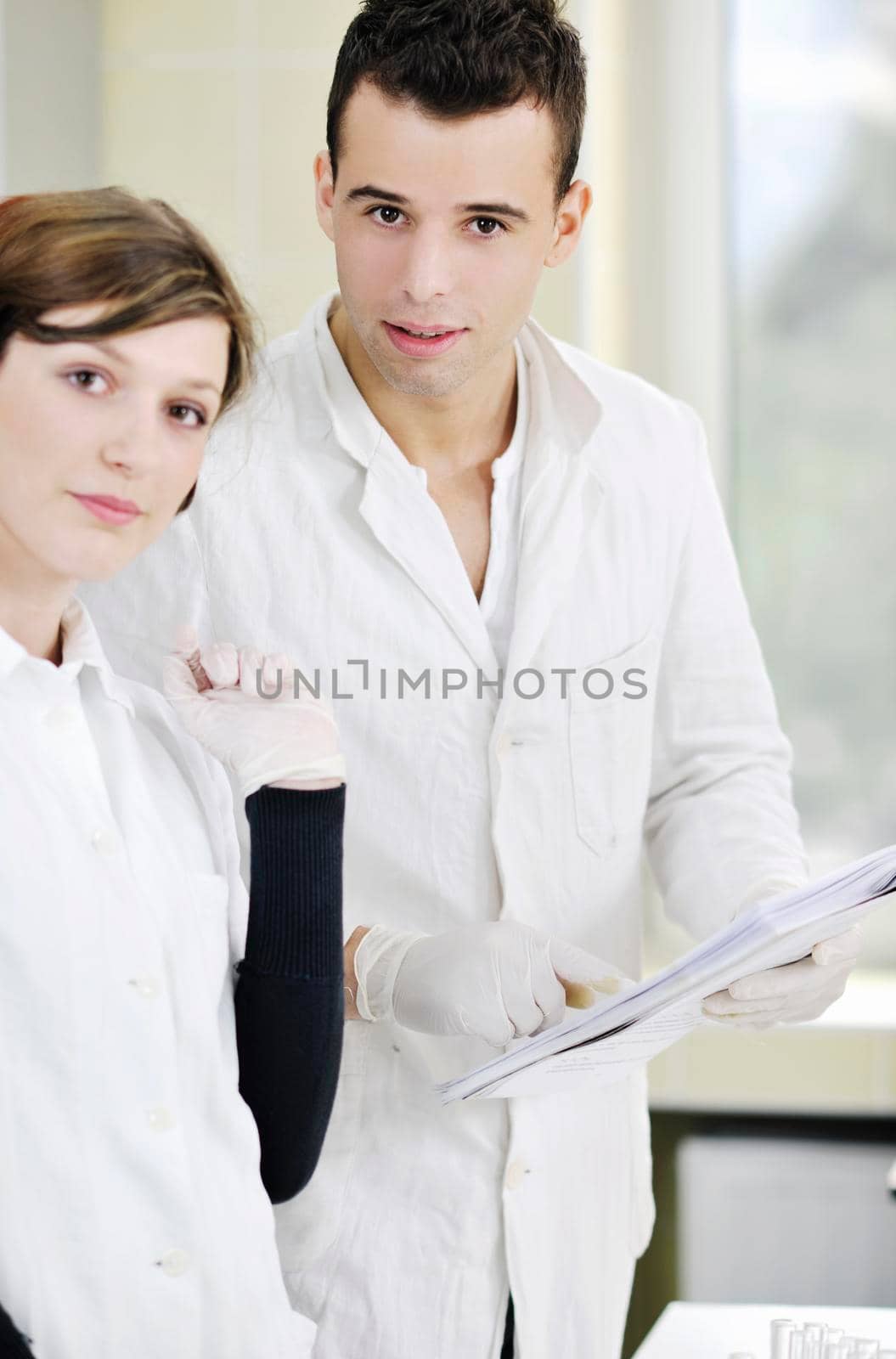 young students couple making test in bright labaratory