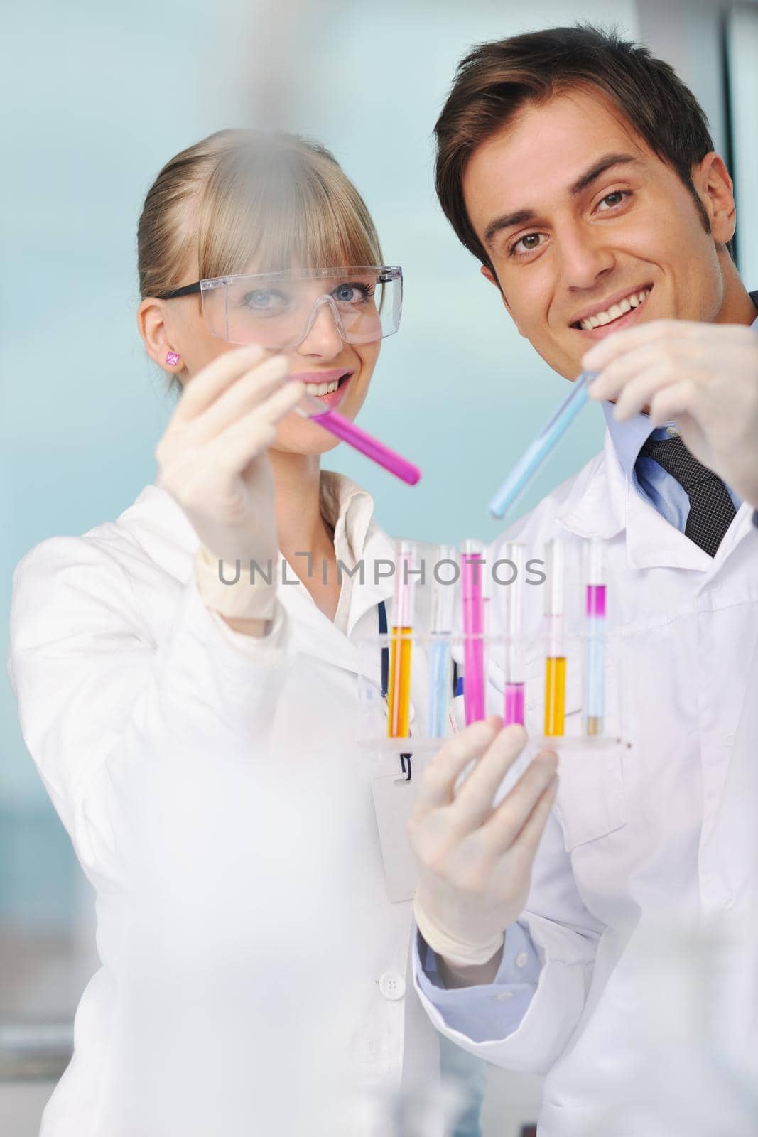 science and research biology chemistry an dmedicine  youn people couple in bright modern  lab