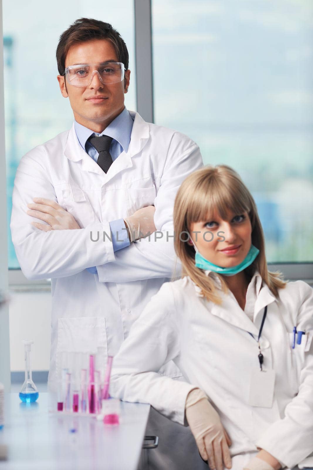 science and research biology chemistry an dmedicine  youn people couple in bright modern  lab