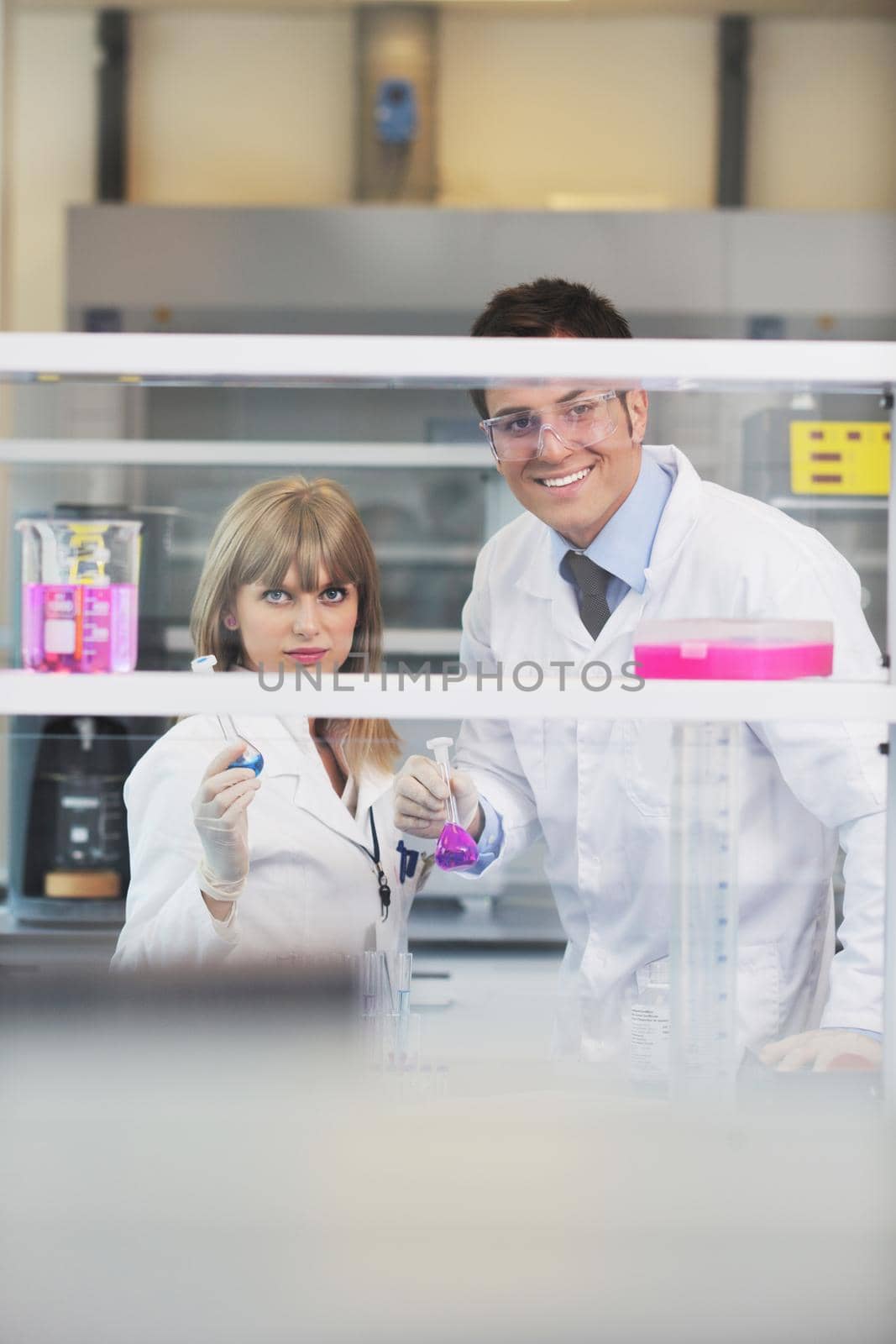 science and research biology chemistry an dmedicine  youn people couple in bright modern  lab