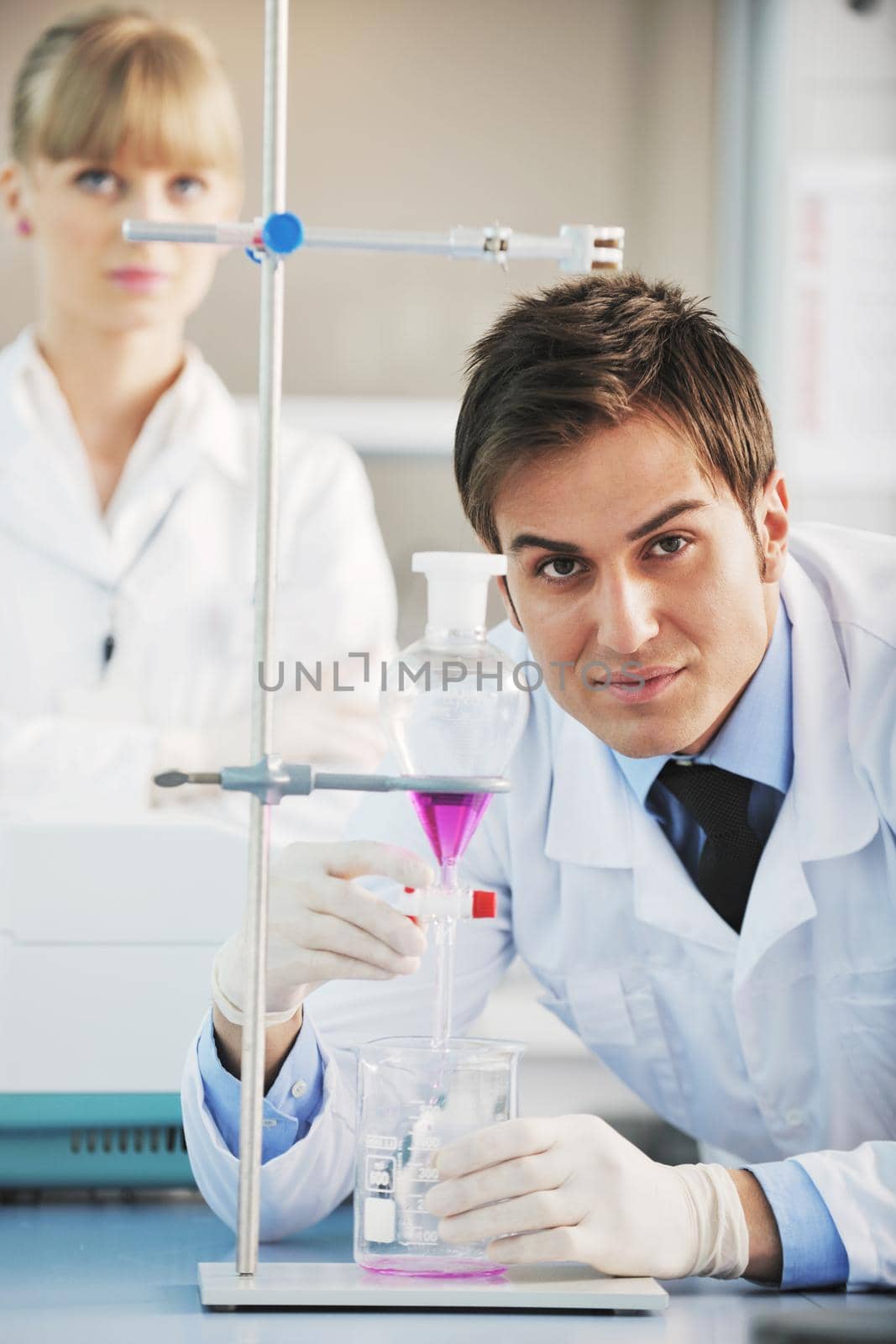 science and research biology chemistry an dmedicine  youn people couple in bright modern  lab