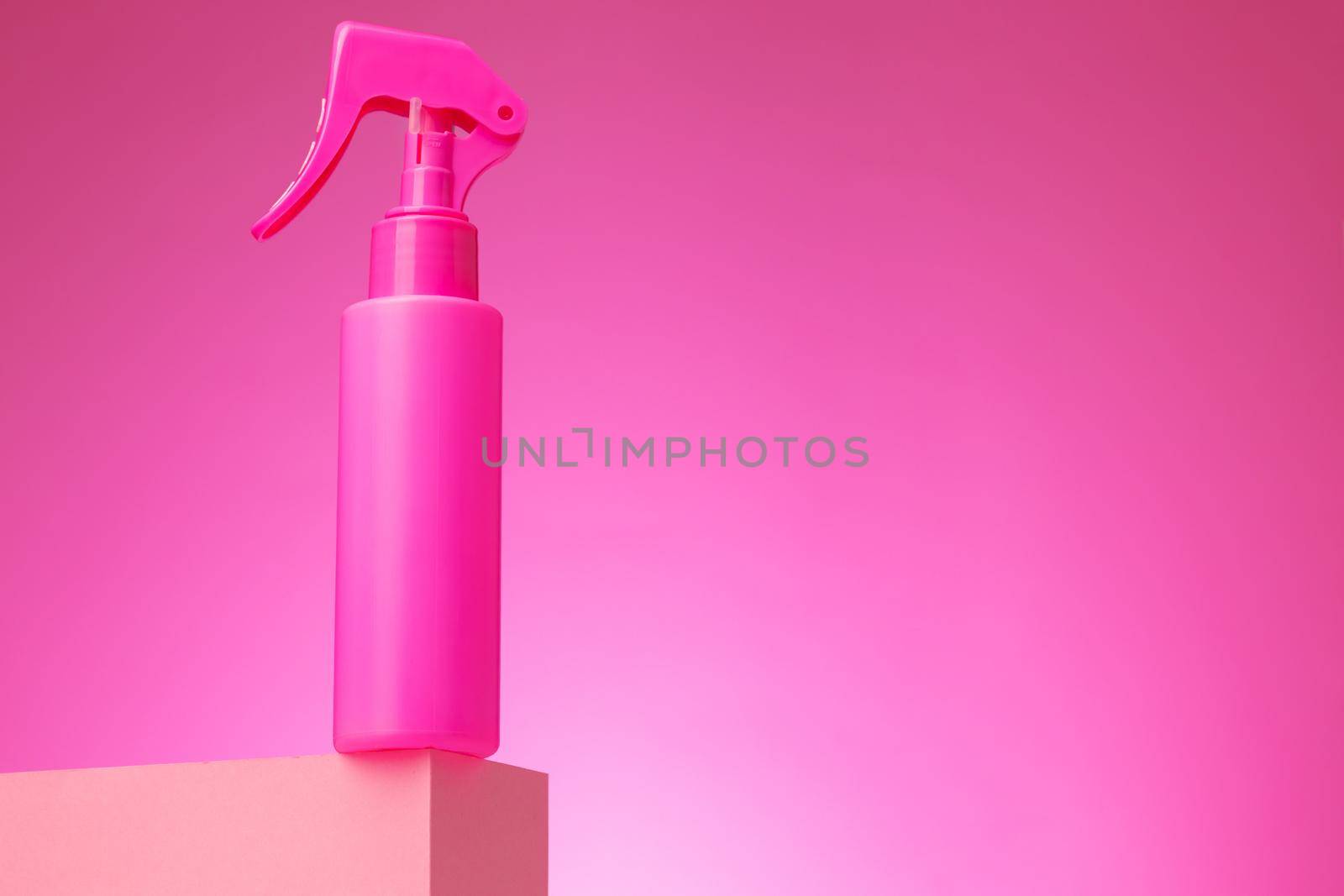 Skincare beauty products container against pink background, copy space