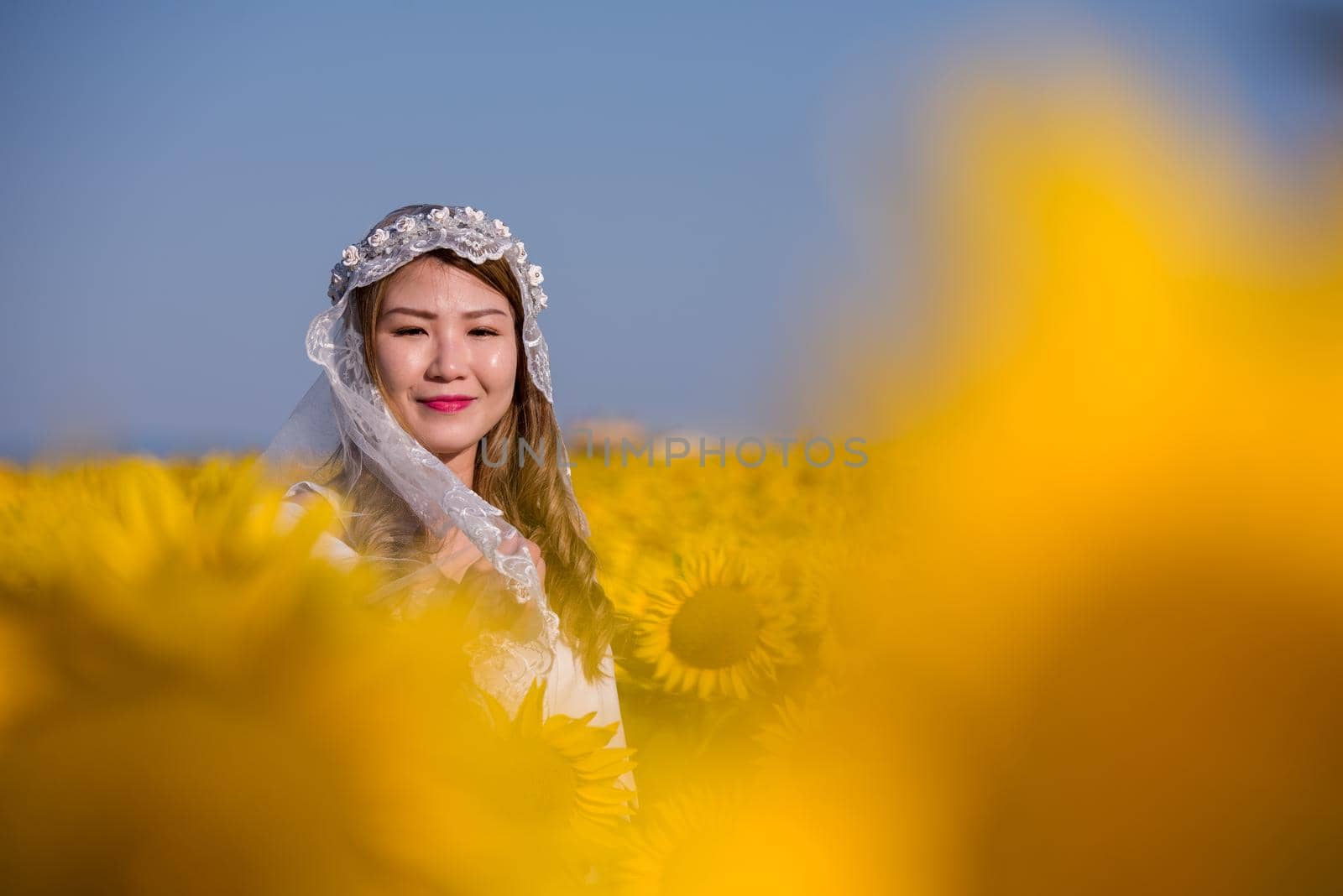 asian woman at sunflower field by dotshock