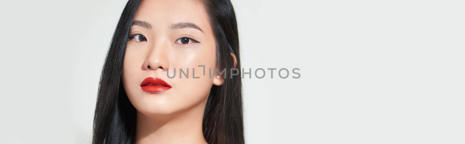 Beautiful woman asian face close up studio .She is catching hair