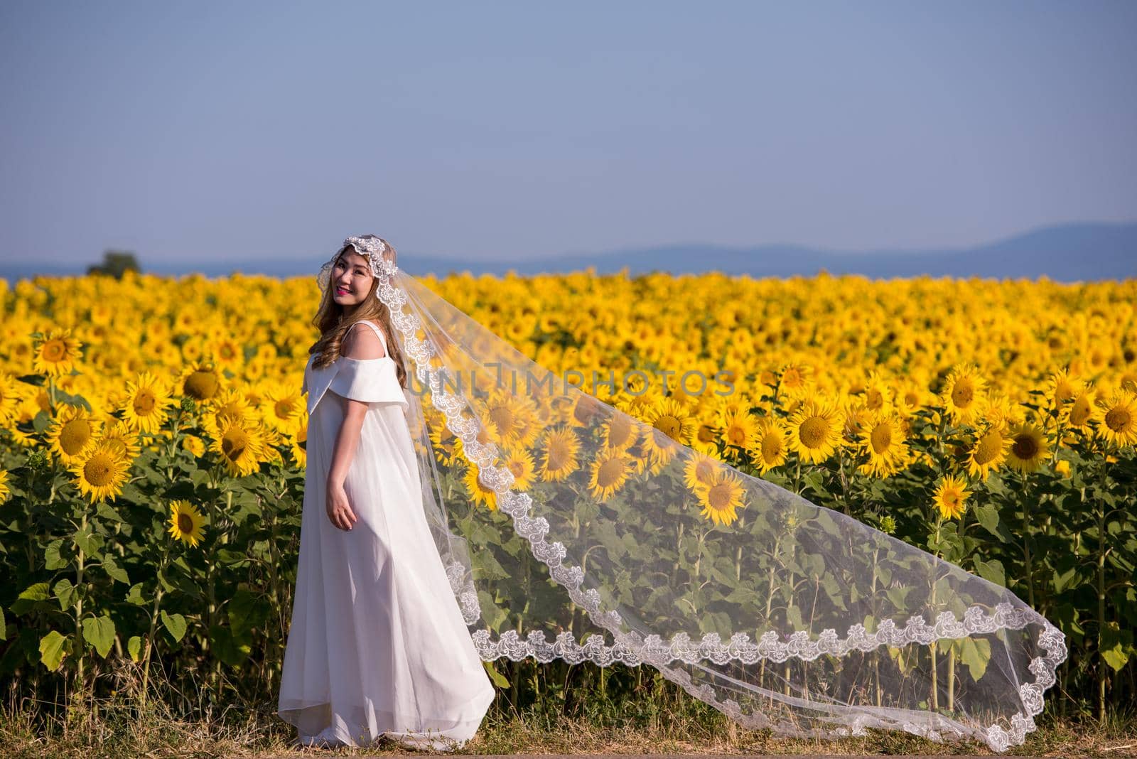asian woman at sunflower field by dotshock