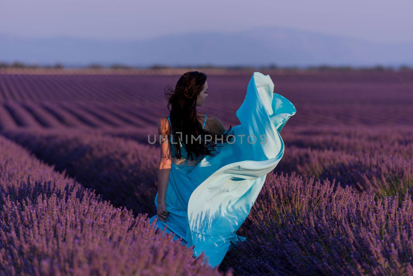 woman in lavender flower field by dotshock