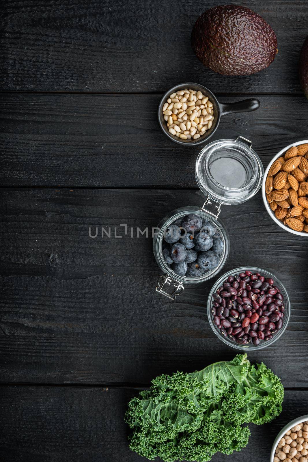 Healthy food clean selection, top view with space for text, on black wooden background.