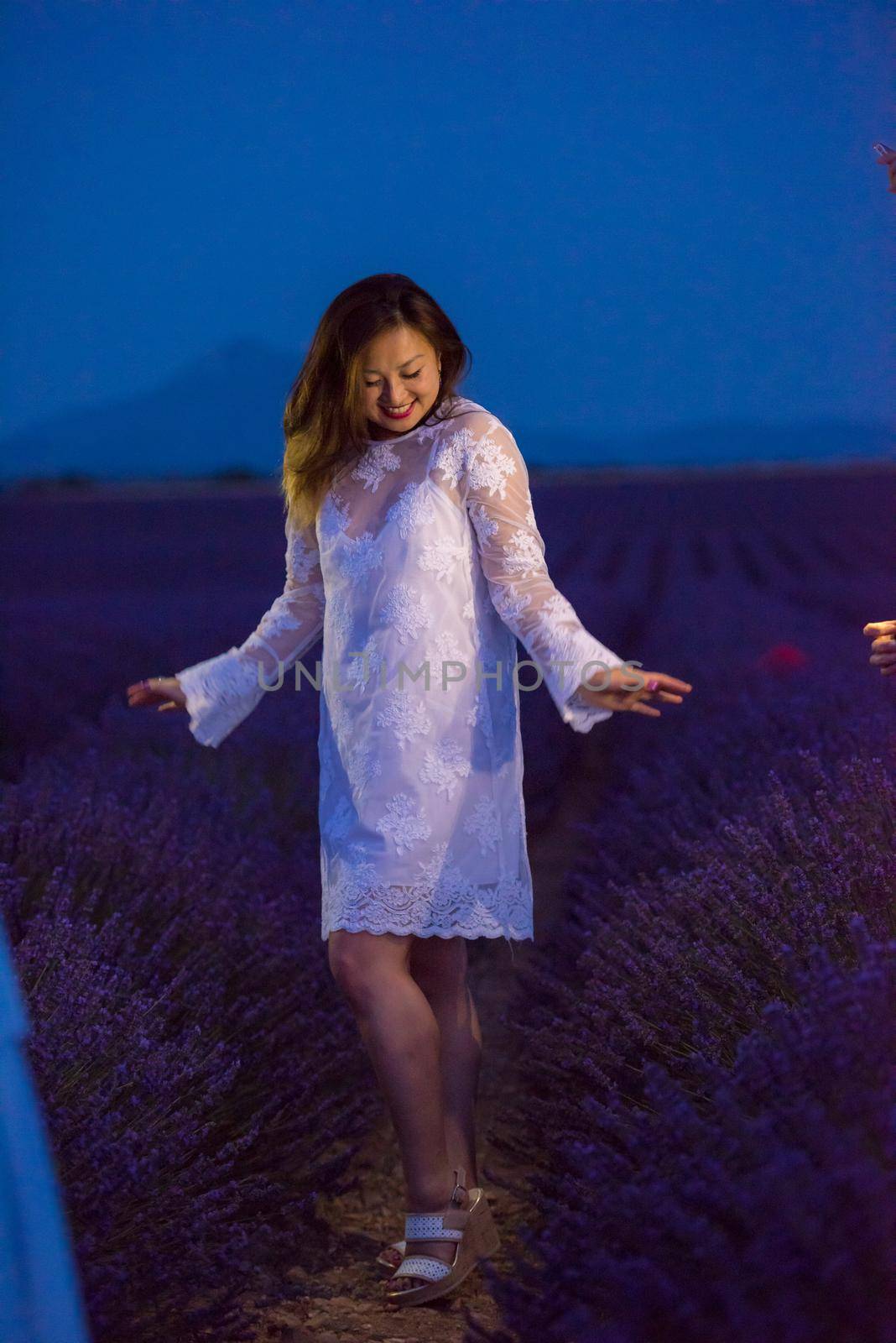 portrait of and asian woman in lavender flower field by dotshock