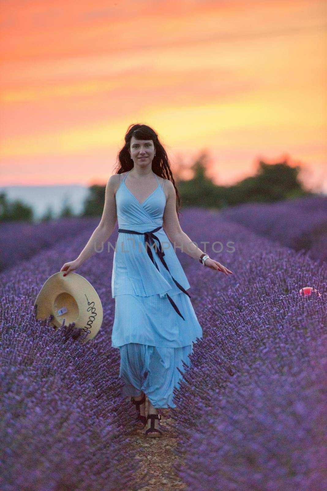 woman portrait in lavender flower fiel in sunset and night time
