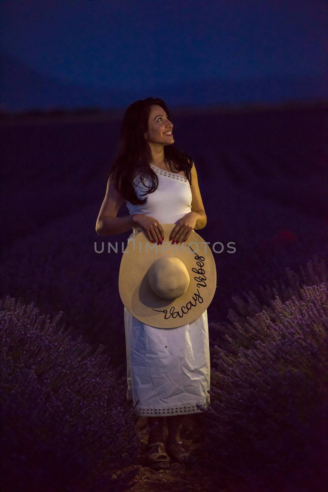 woman portrait in lavender flower fiel in sunset and night time