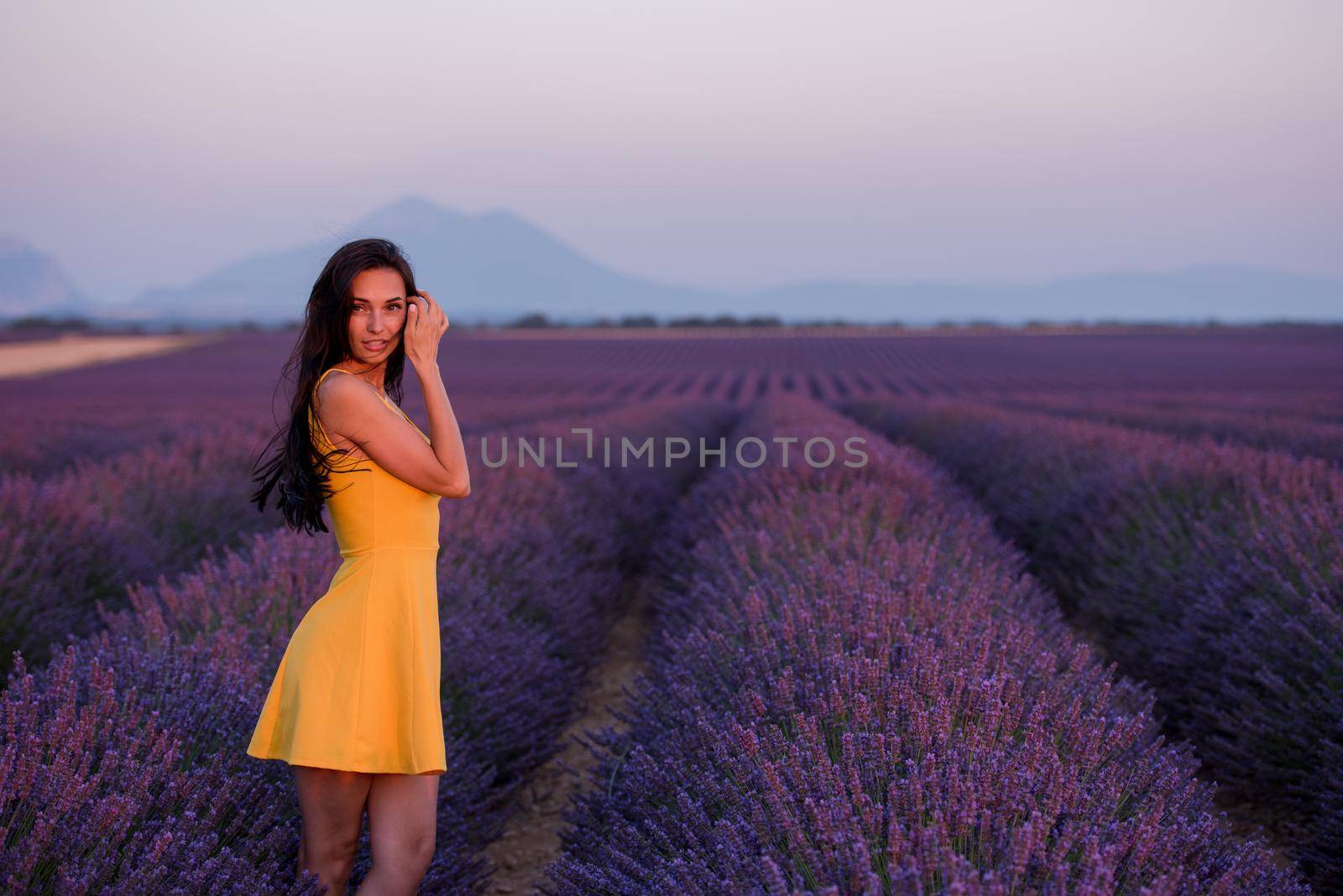 woman in yellow dress at lavender field by dotshock