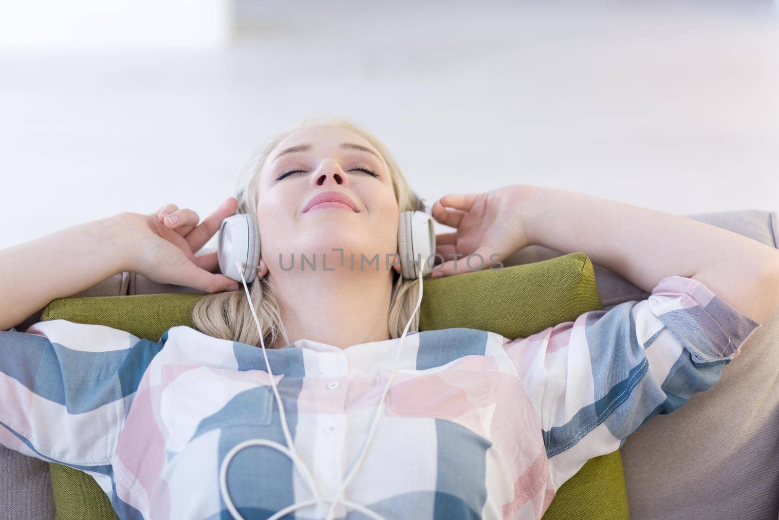 girl enjoying music through headphones by dotshock