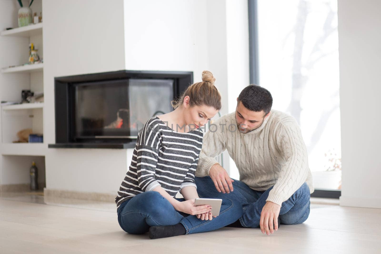 Young Couple using digital tablet on cold winter day by dotshock