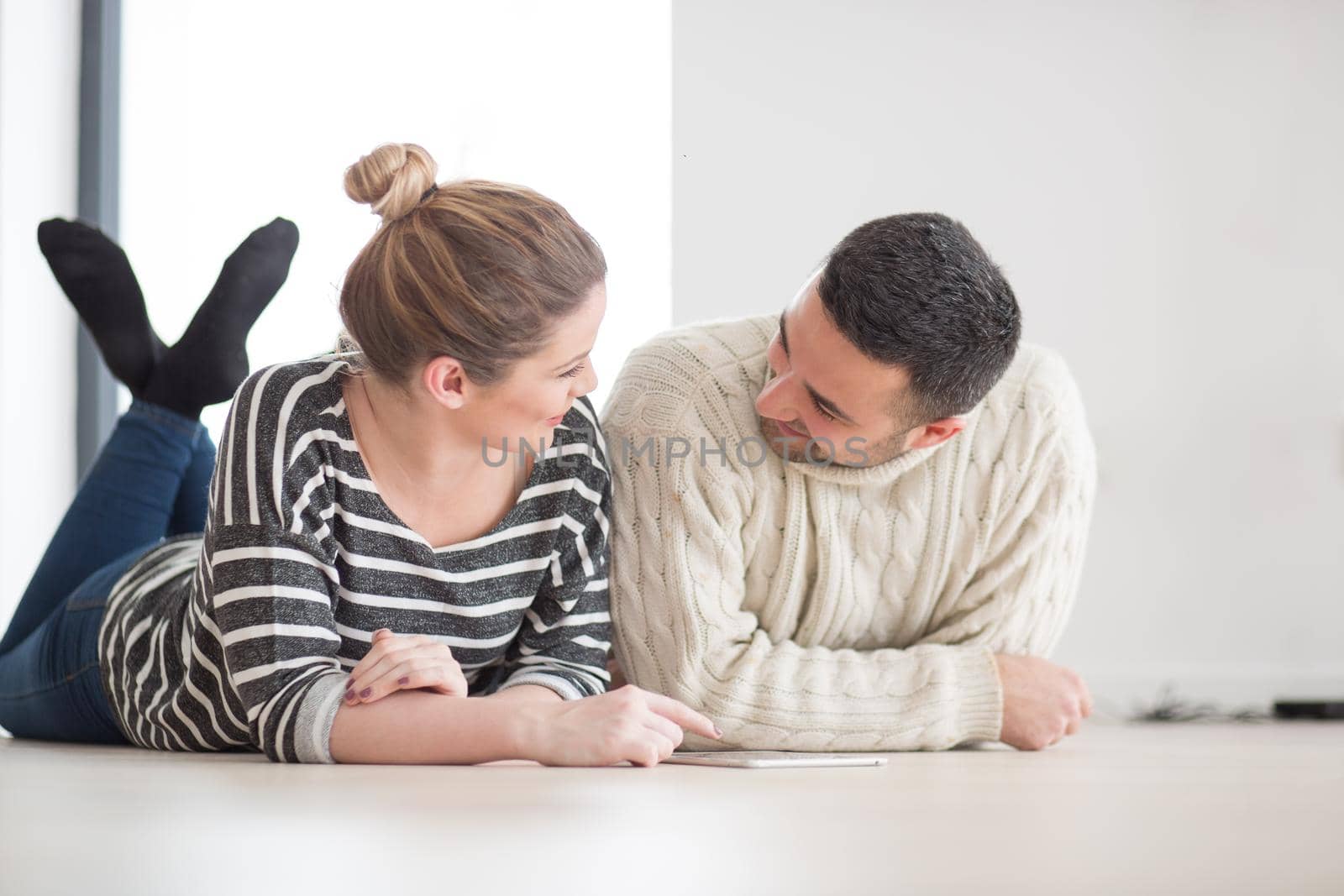 Young Couple using digital tablet on cold winter day by dotshock