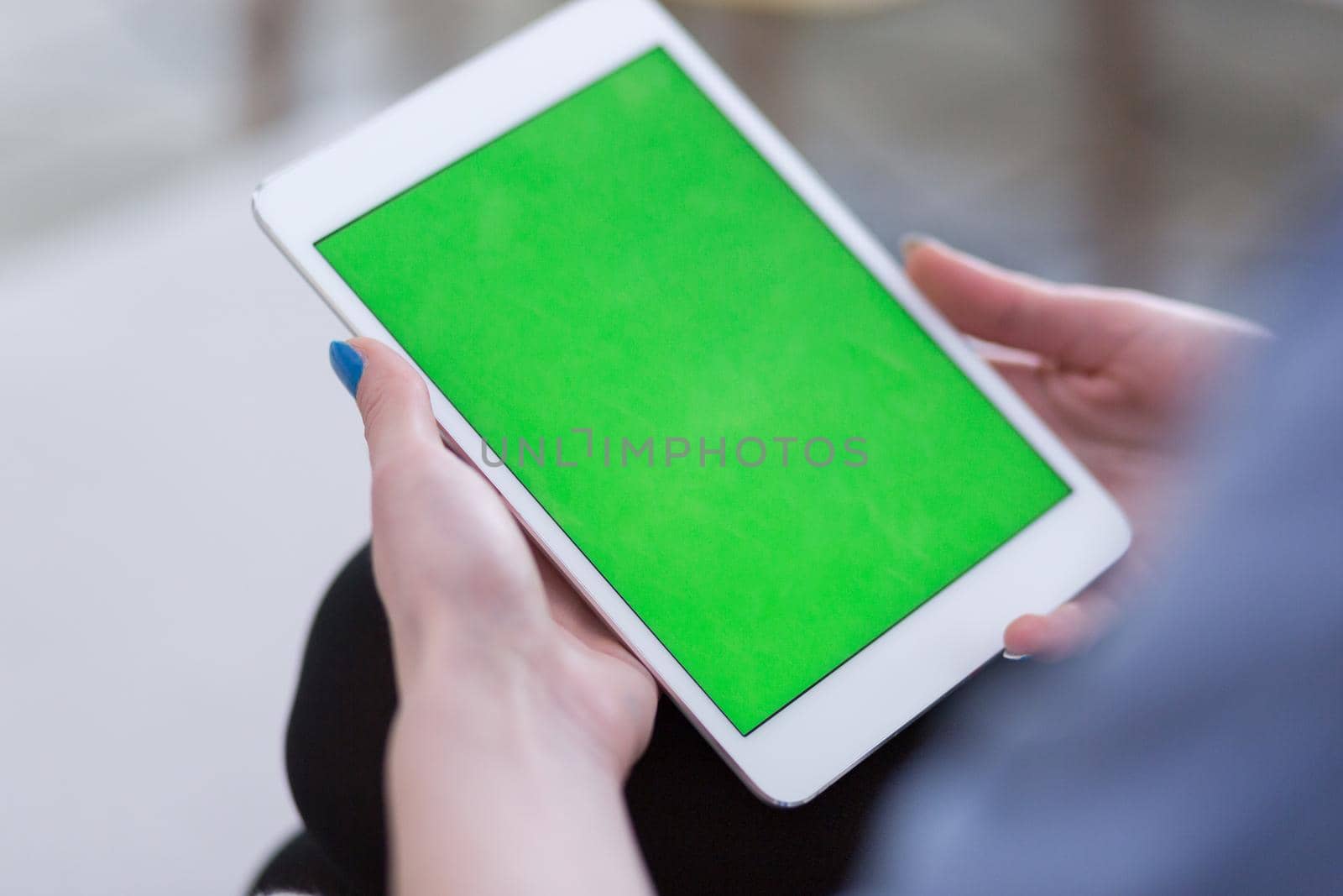 young happy woman on sofa using tablet computer at luxury home