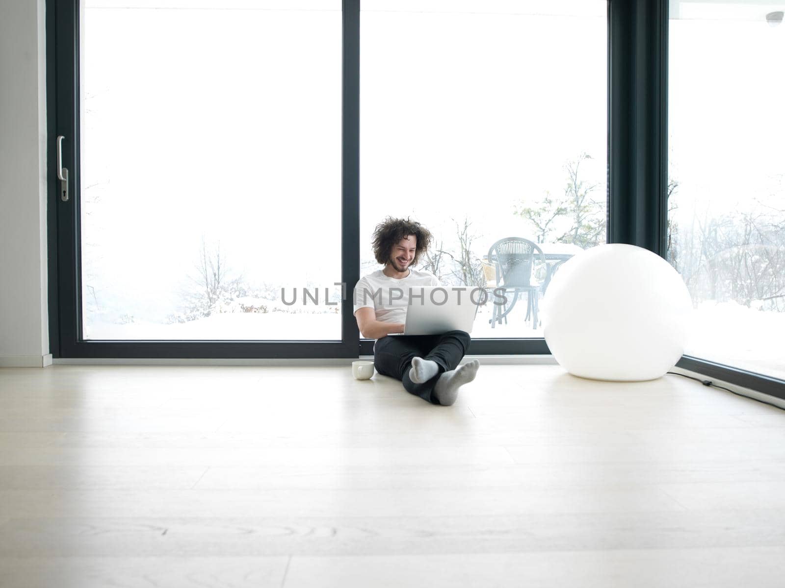 Real man Using laptop on the floor At Home  Enjoying Relaxing