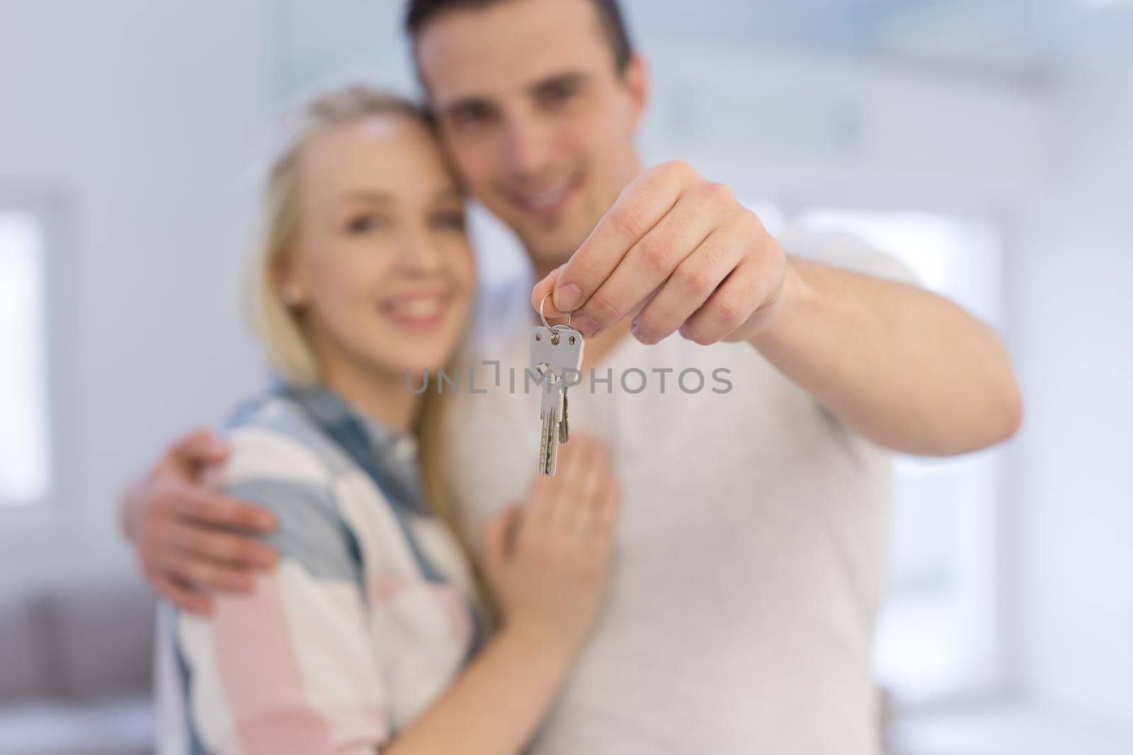 couple showing a keys of their new house by dotshock