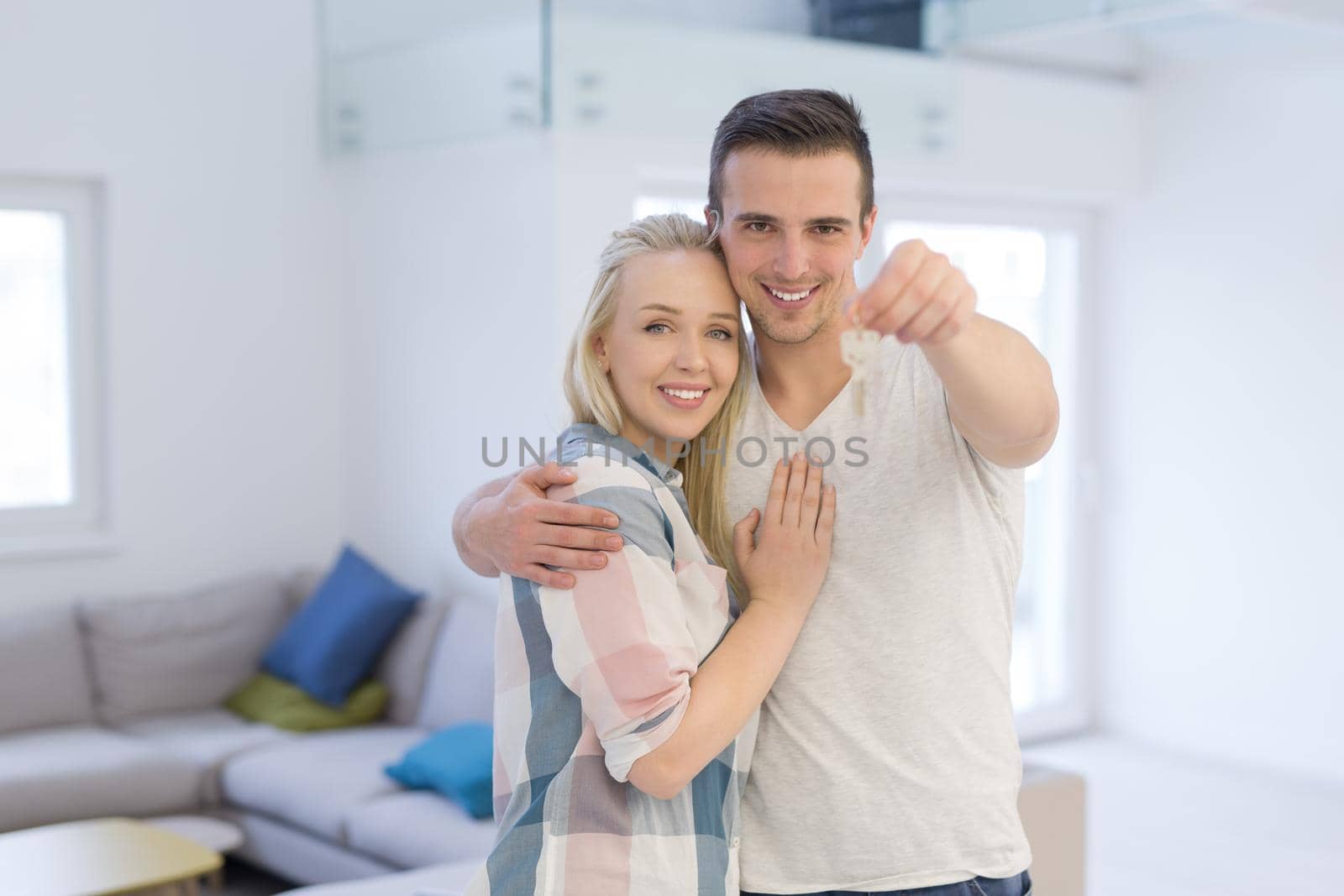 couple showing a keys of their new house by dotshock