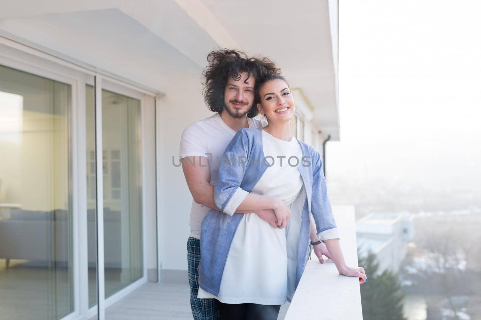 Couple hugging on the balcony by dotshock