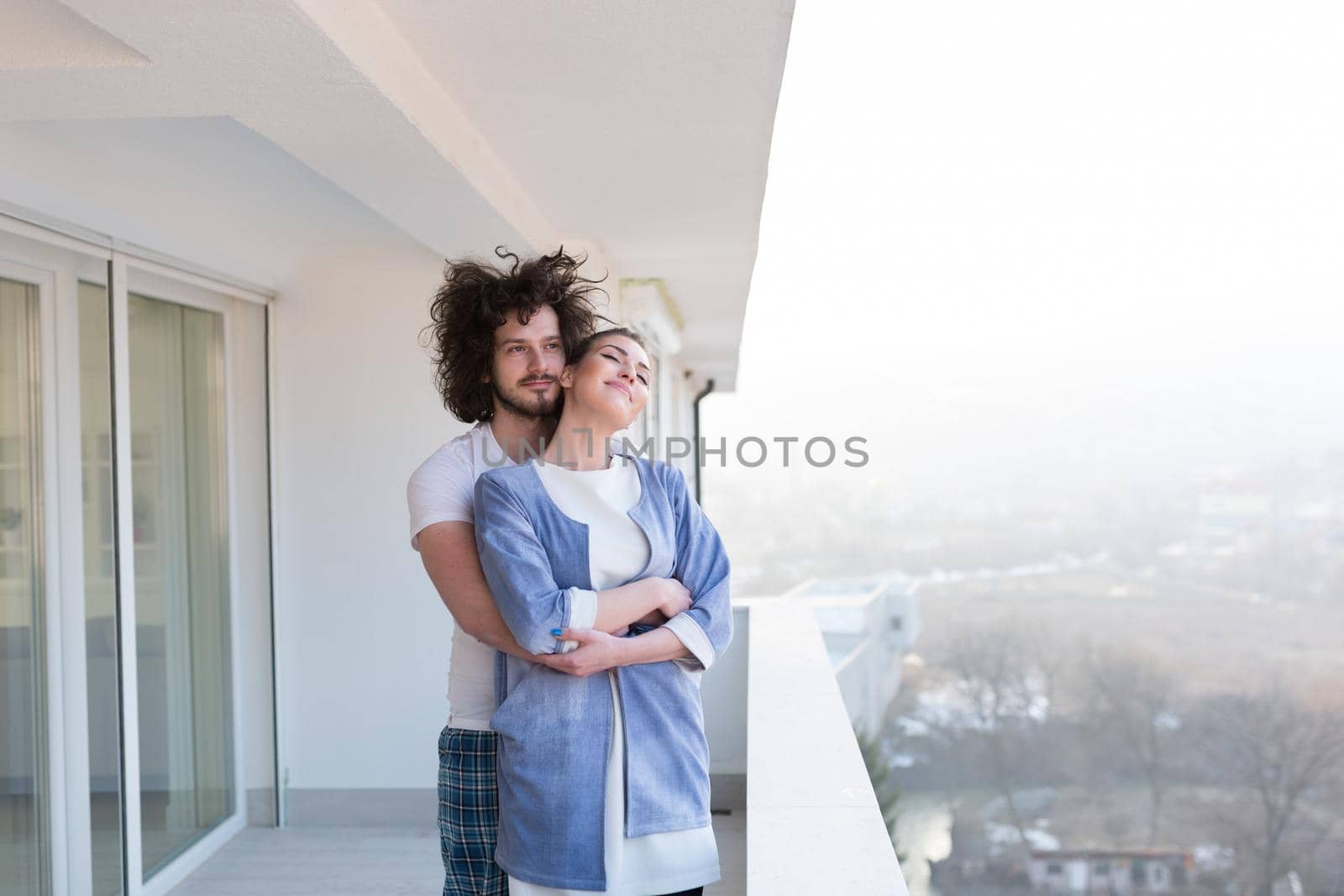 Couple hugging on the balcony by dotshock