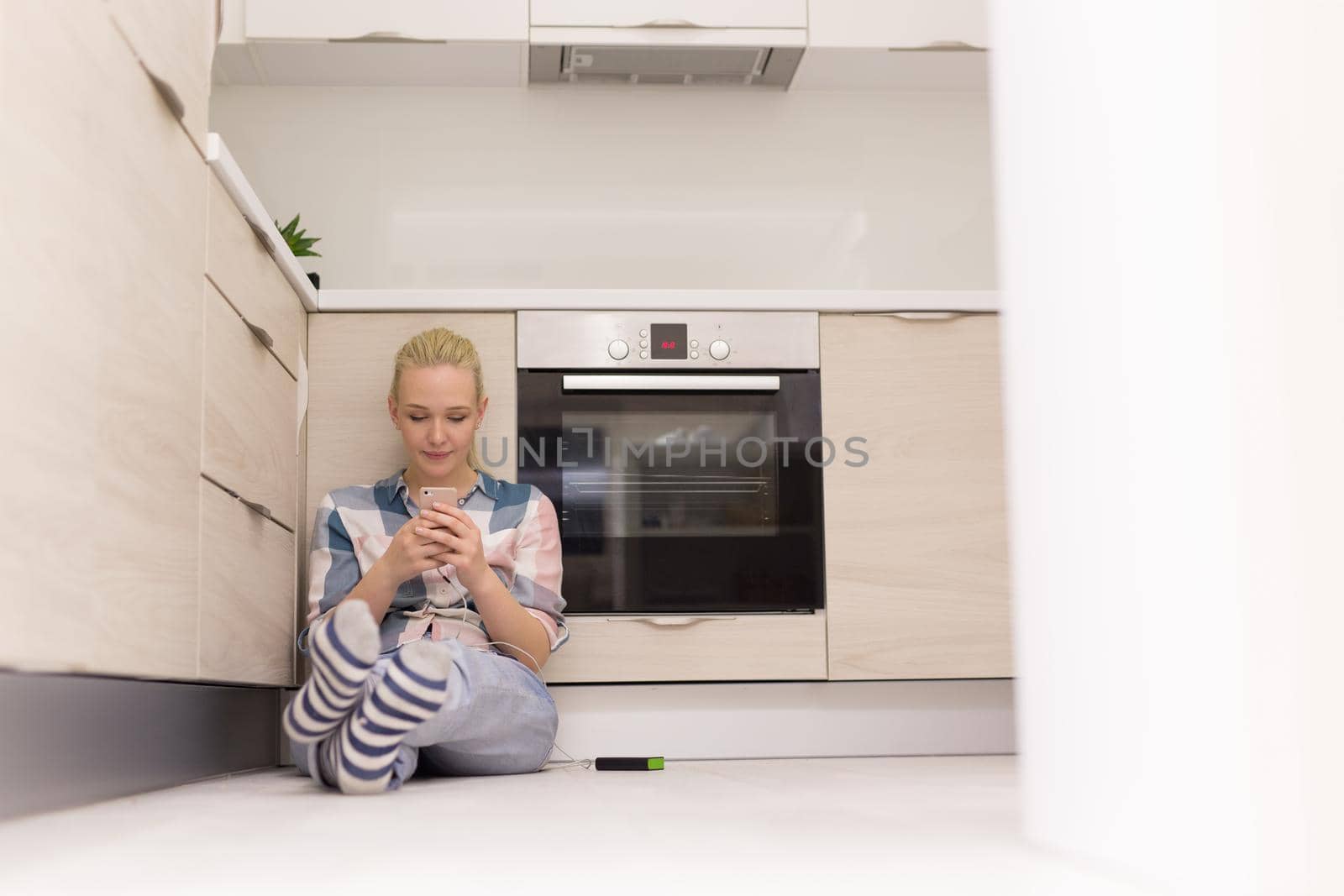 young women using mobile phone at home by dotshock