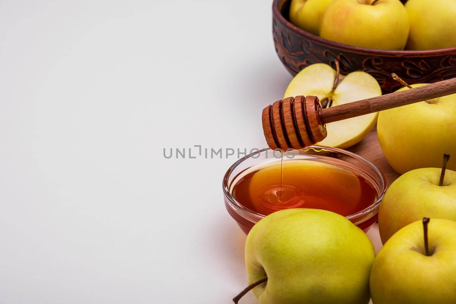 Fresh ripe whole and cut yellow apples with honey lie on table. Selective focus. Copy space.