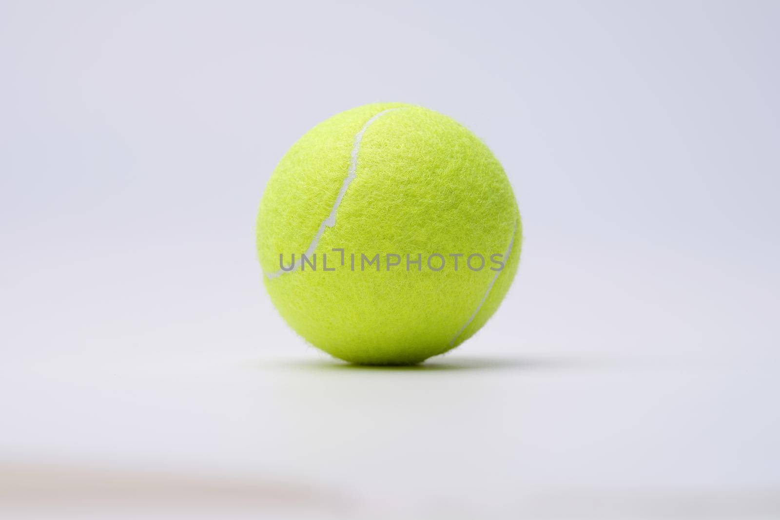 Bright lime tennis ball on white background closeup by kuprevich