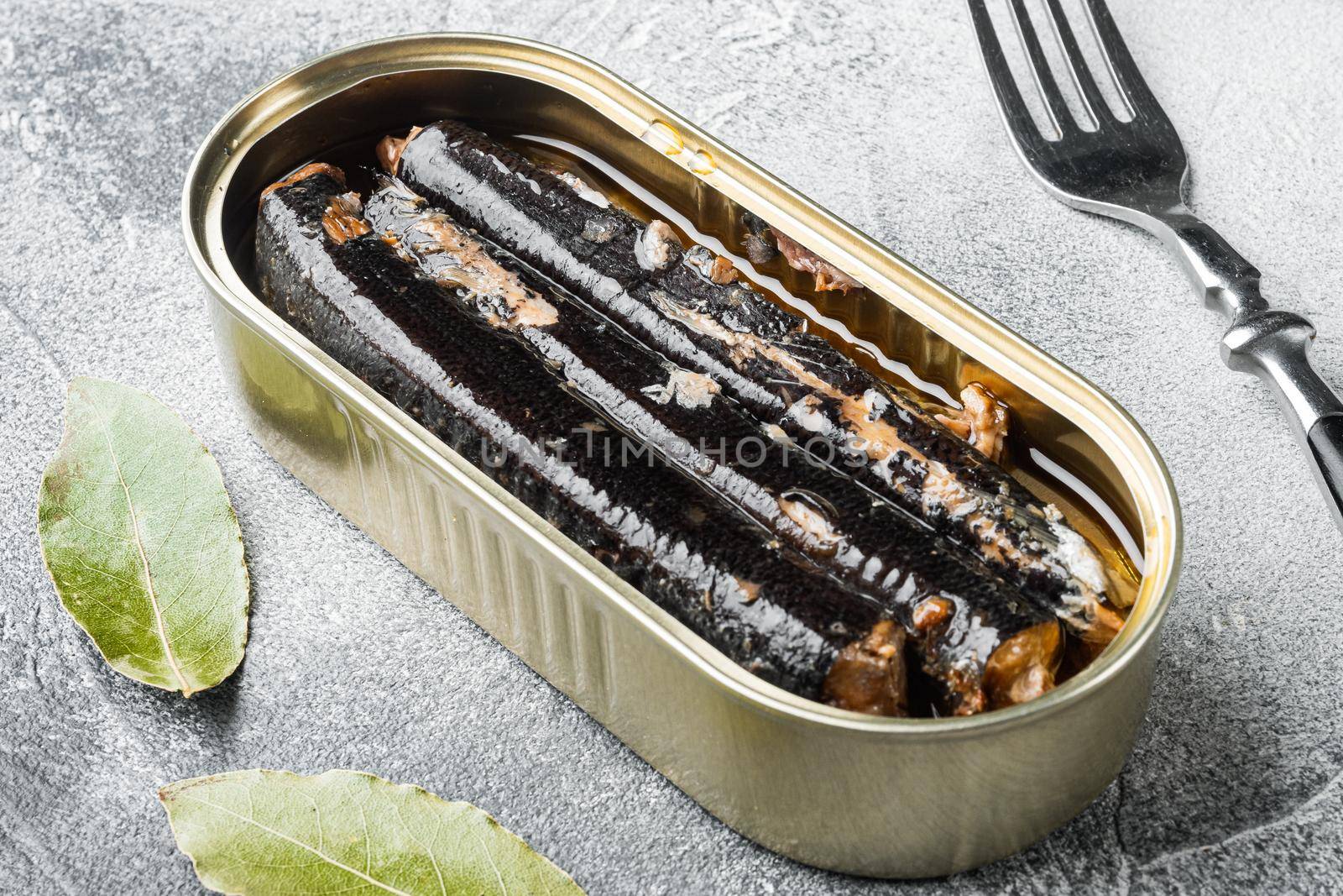 Open canned fish set, on gray stone table background